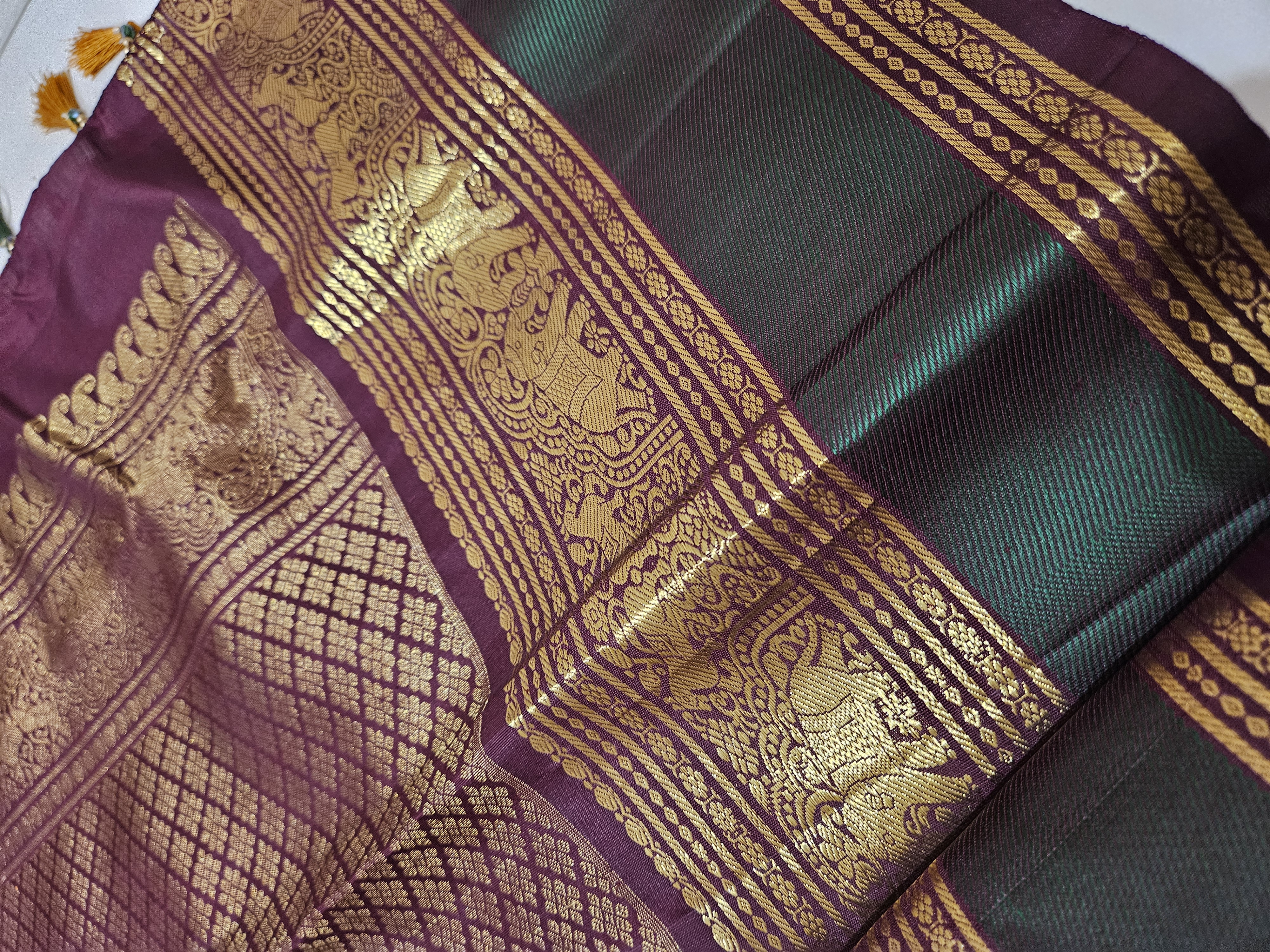 Rust orange and brown pure Kanchipuram silk saree featuring intricate handwoven 2gm zari border with traditional motifs.