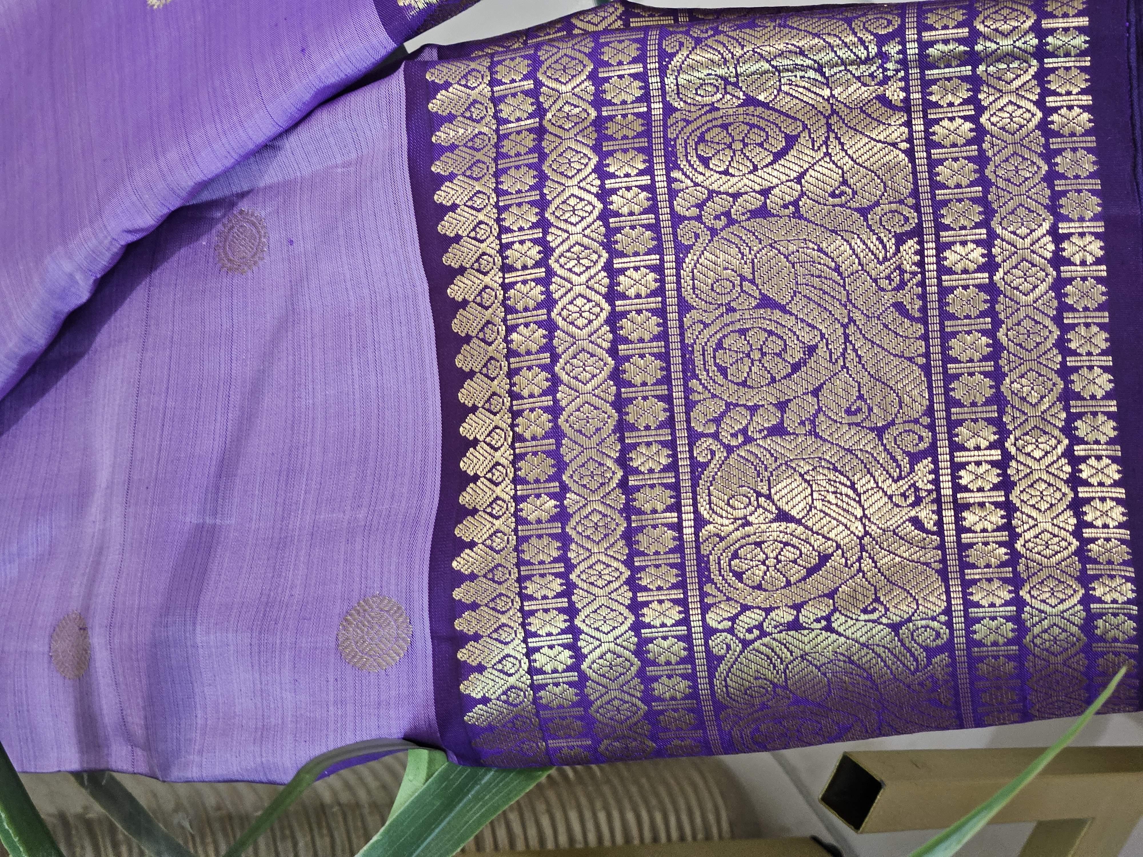 Radiant purple Kanchipuram silk saree with intricate 2gm pure gold zari peacock motifs and geometric border design.