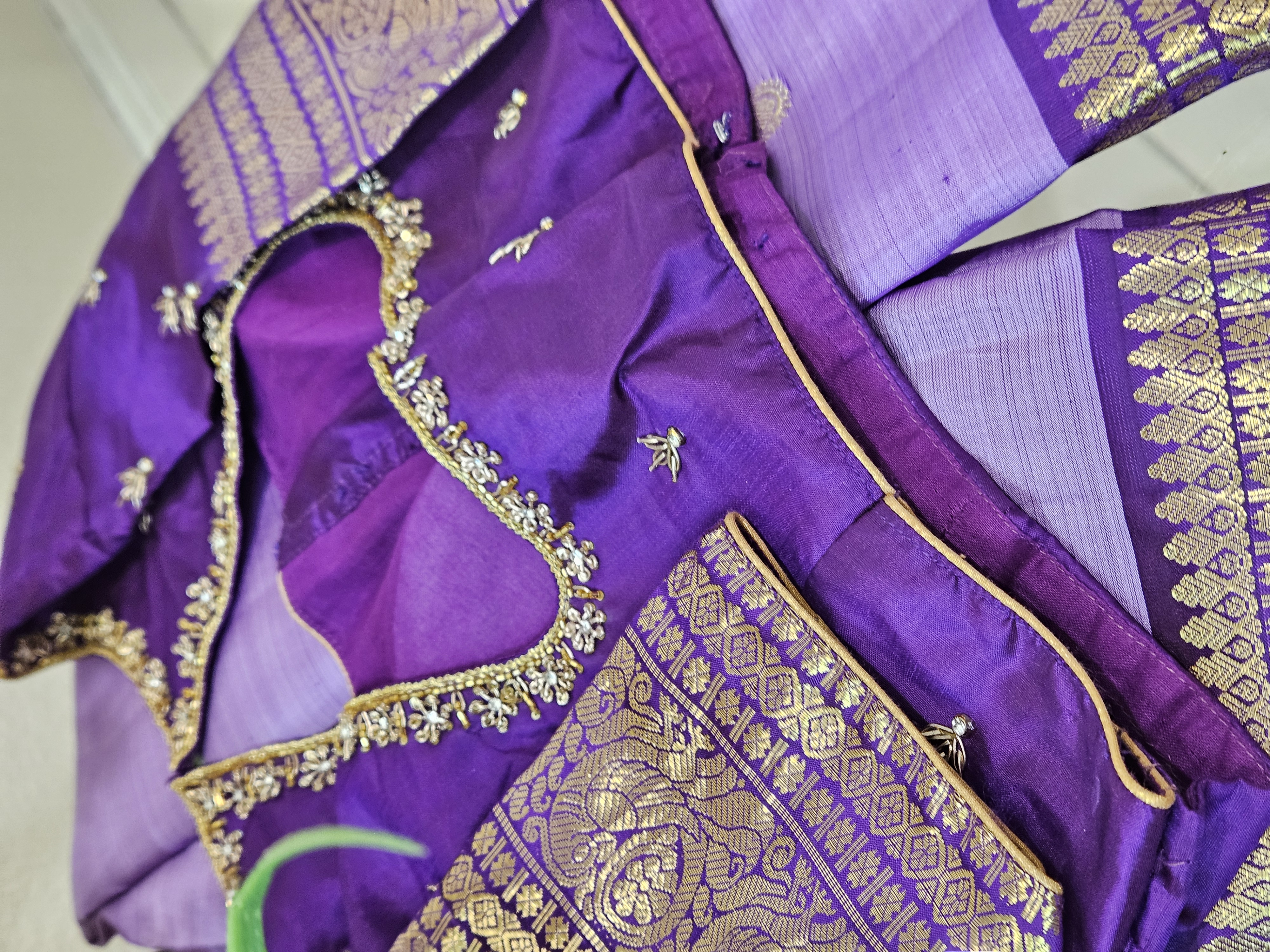 Radiant purple Kanchipuram silk saree with intricate 2gm pure gold zari work and detailed gold embroidery, ideal for weddings.