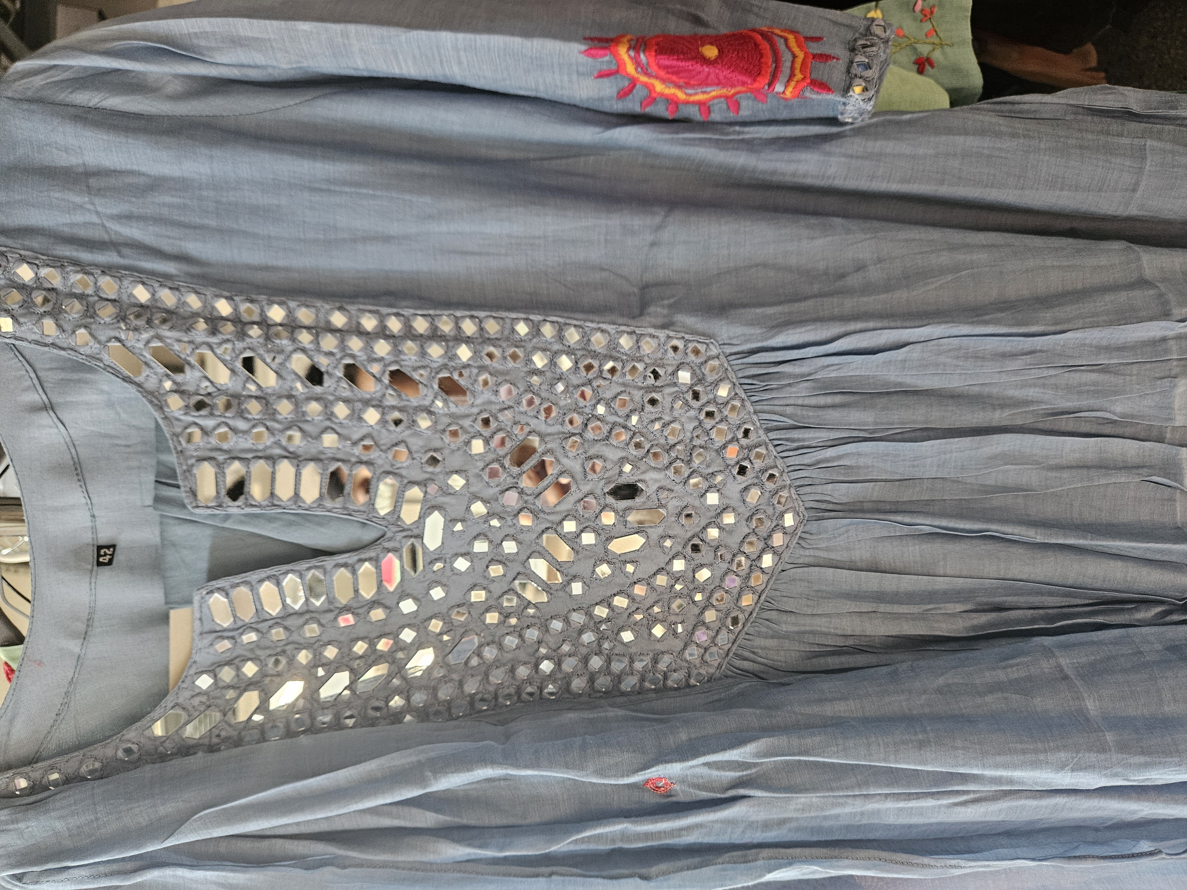 Dusty blue mul Chanderi Anarkali dress featuring mirror work on the neckline and pink embroidered accents on the sleeves.