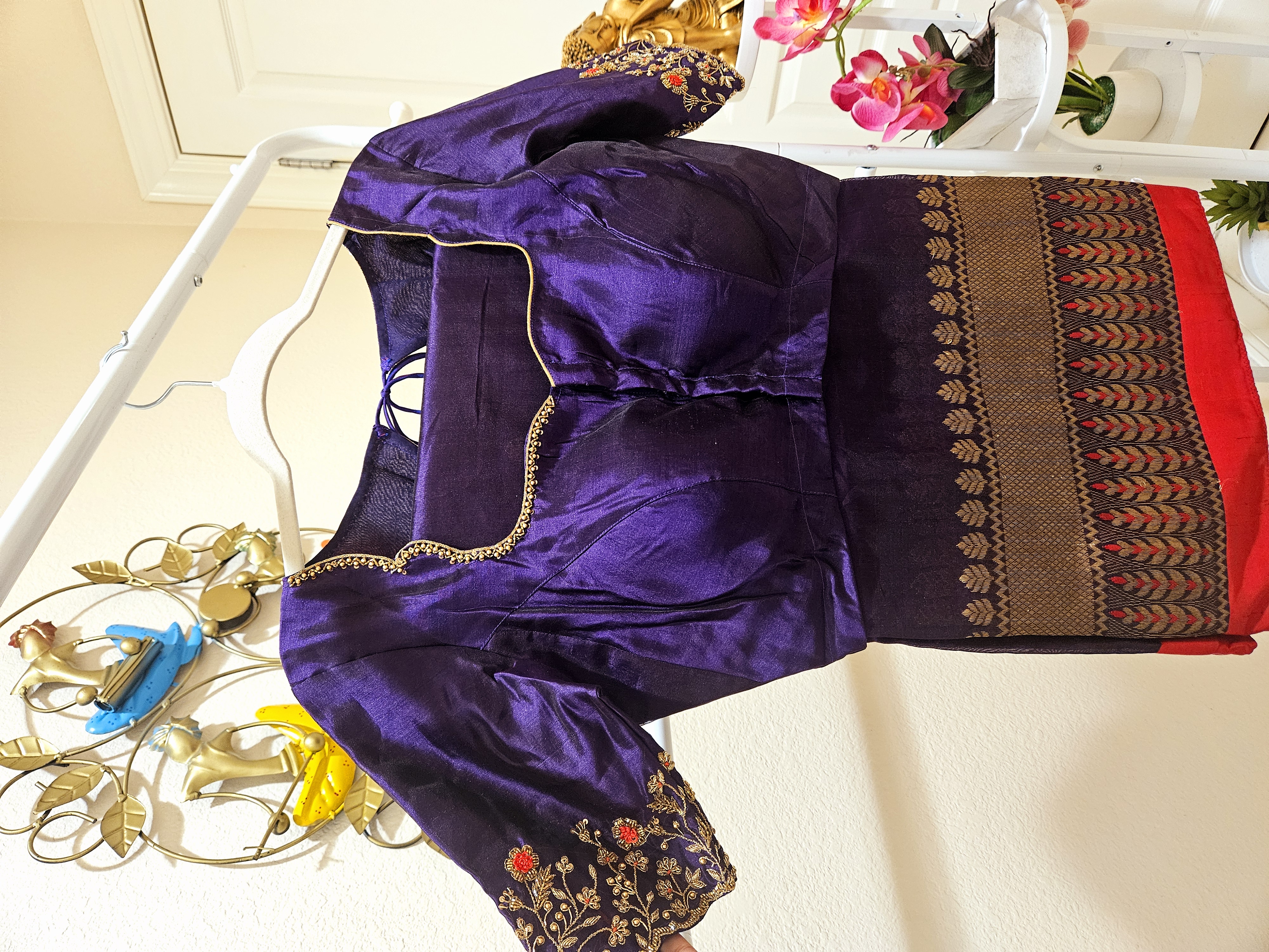 Deep purple Chanderi silk saree blouse with golden zari trim, floral embroidery on sleeves, and handwoven Indian motifs.