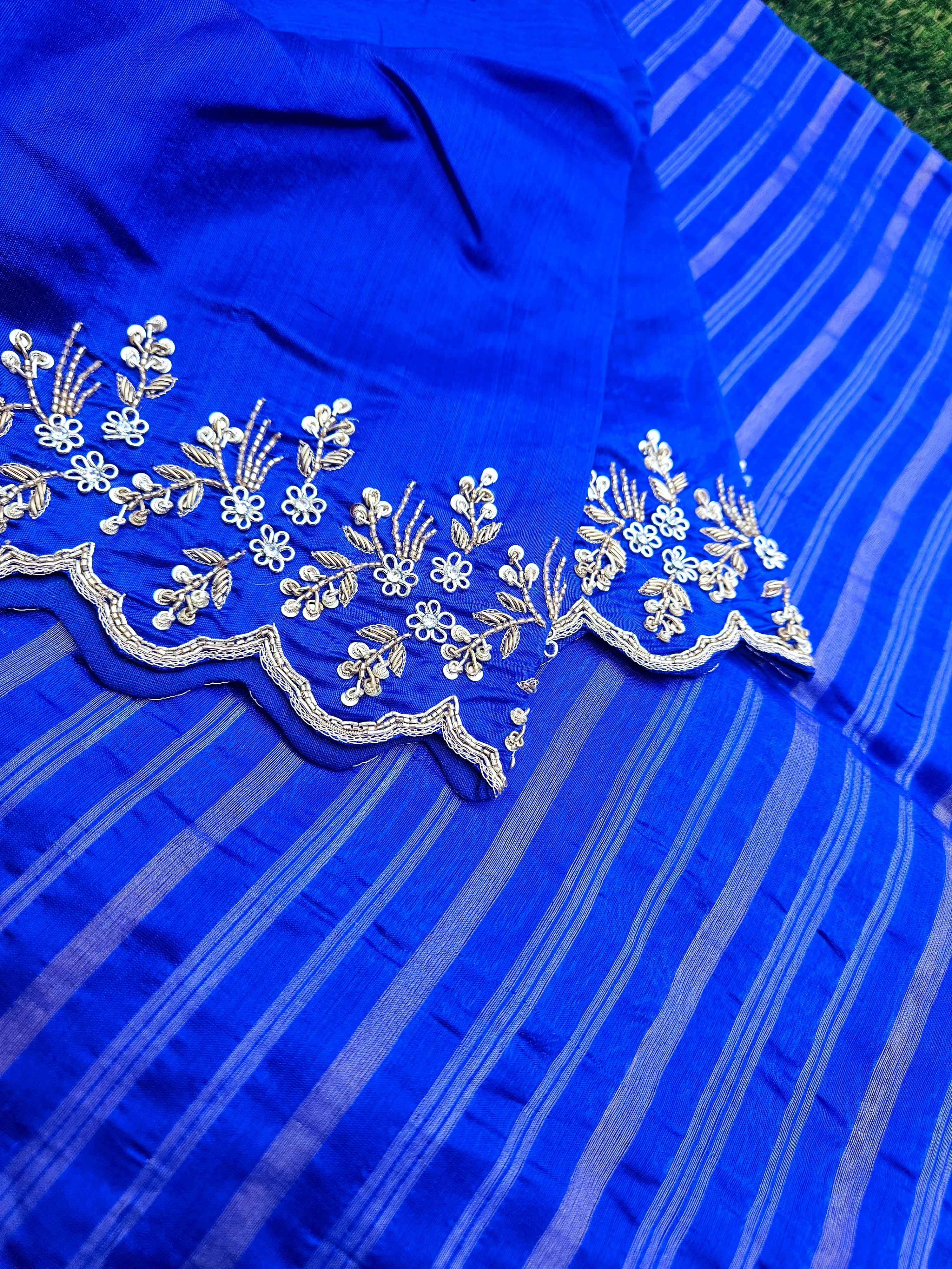Royal blue Chanderi silk saree with handwoven gold zari floral border and subtle striped pattern, ideal for weddings.