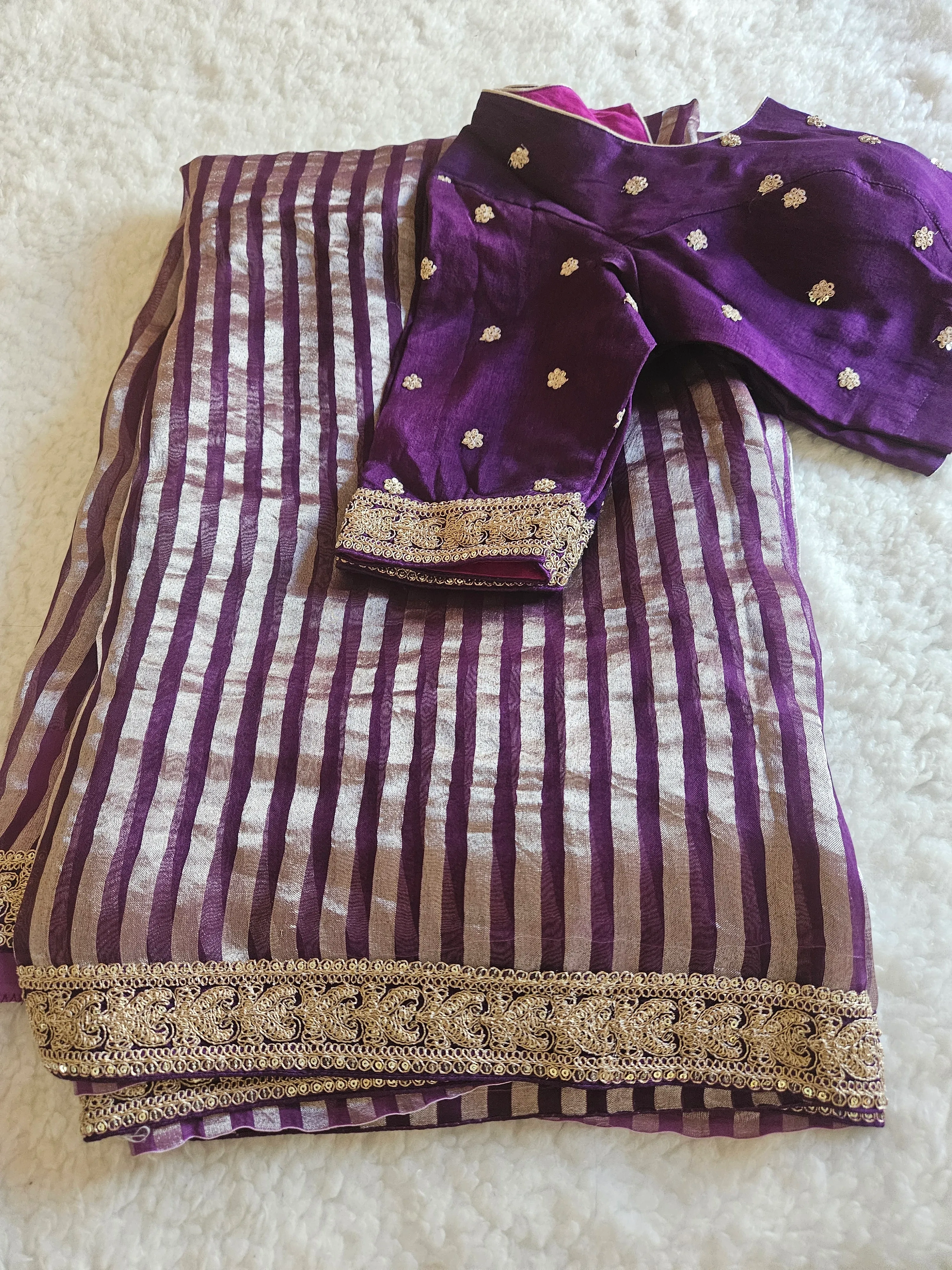 Pure Banarasi tissue silk saree in purple with silver zari stripes, gold floral motifs, and ornate gold border, paired with matching blouse.