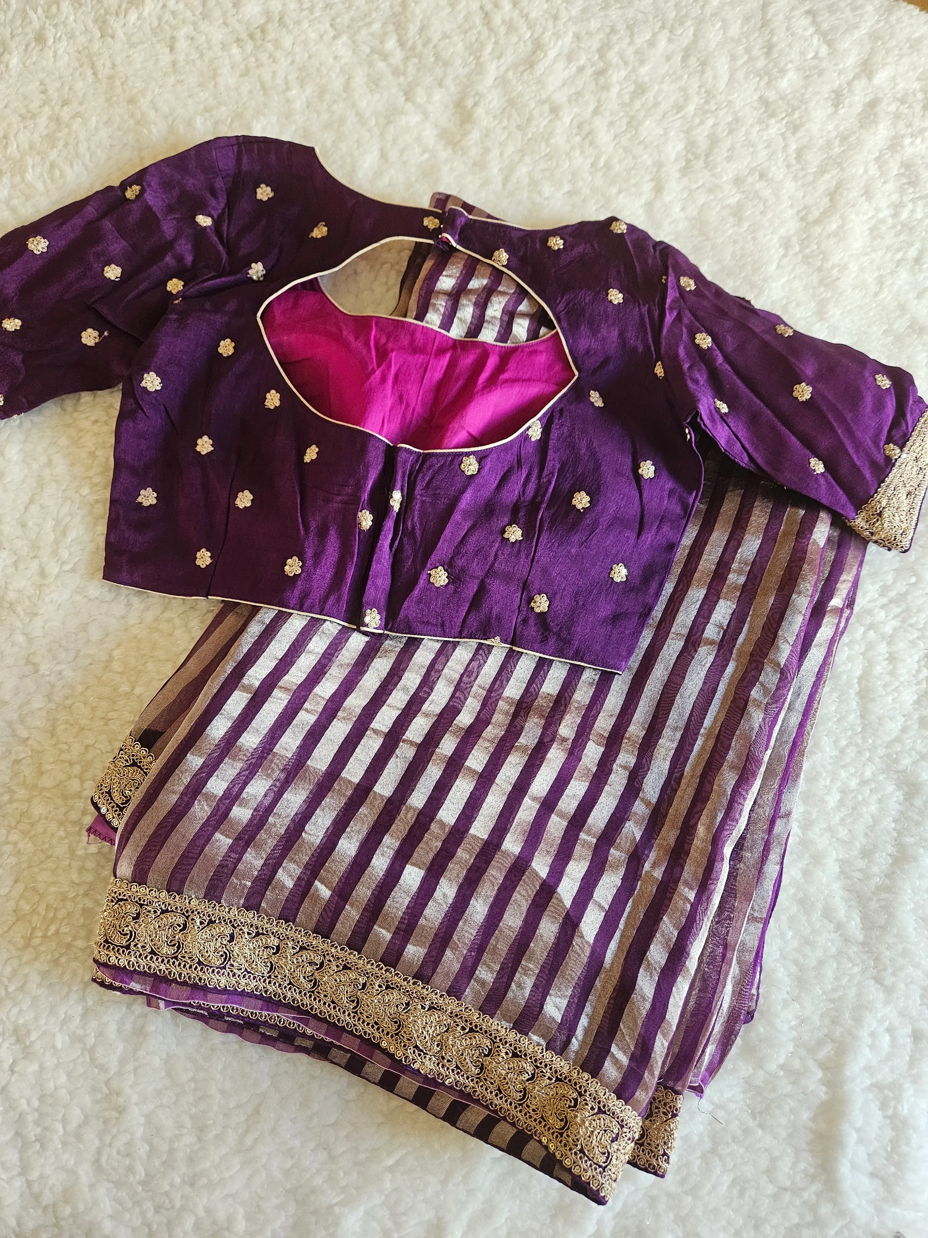Pure Banarasi tissue silk saree in purple with gold zari floral motifs, paired with matching blouse, ideal for weddings