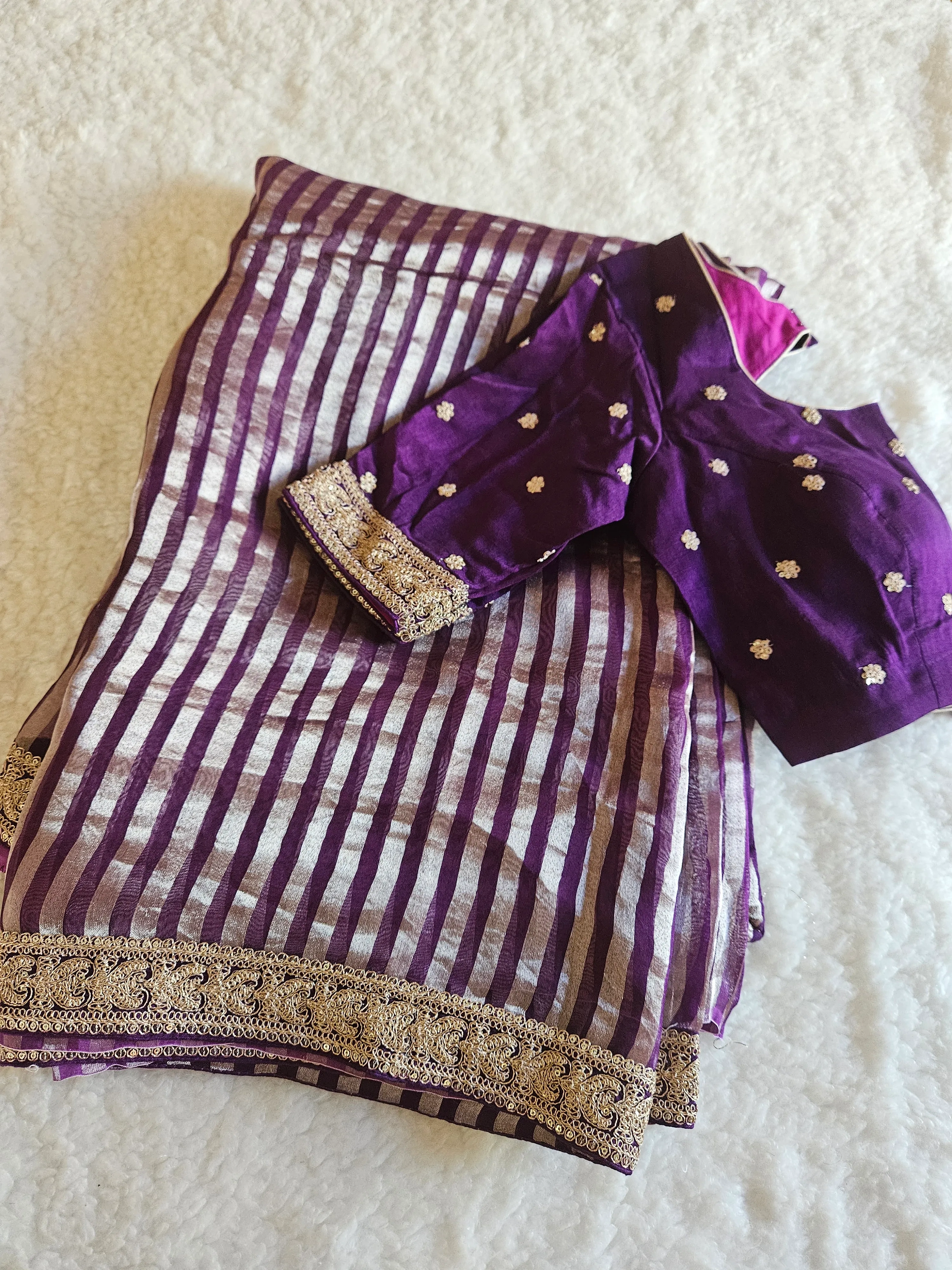 Pure Banarasi tissue silk saree in purple and silver stripes with gold zari floral motifs, paired with a matching blouse.
