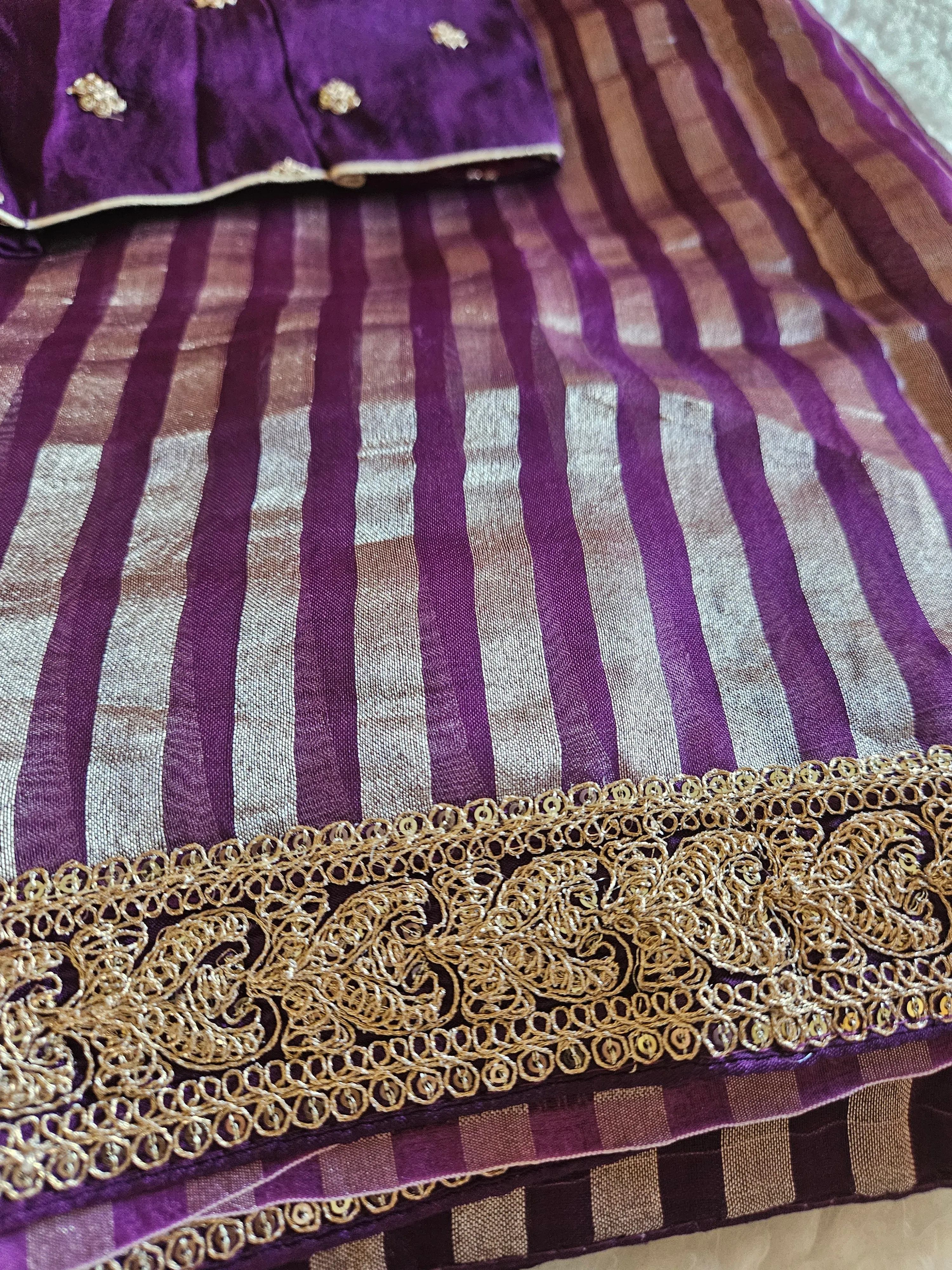 Pure Banarasi tissue silk saree in rich purple with gold zari floral motifs and striped pattern, ideal for weddings.