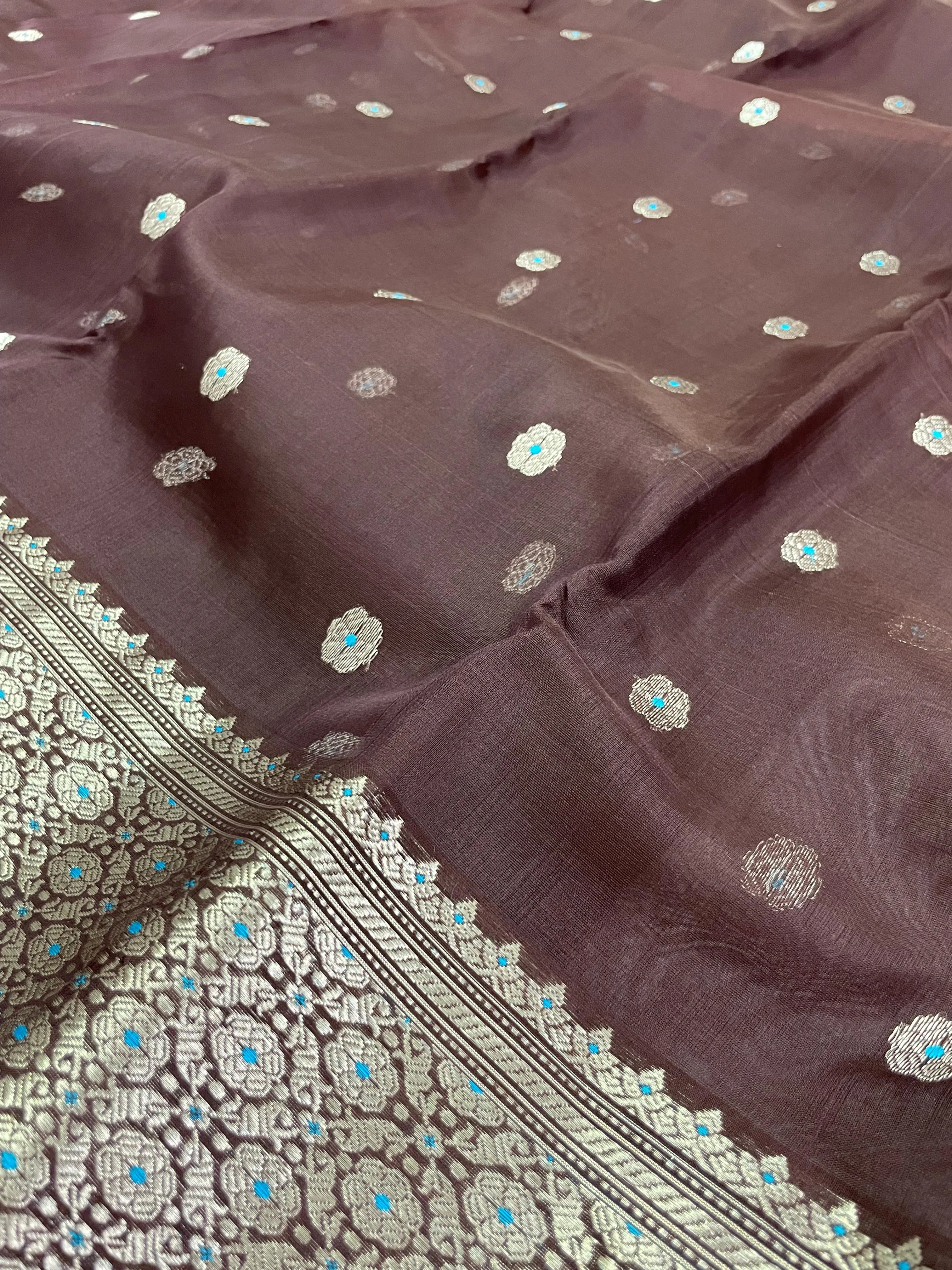 Golden beige handwoven Chanderi silk saree with silver zari floral motifs and intricate border, ideal for weddings and festivals