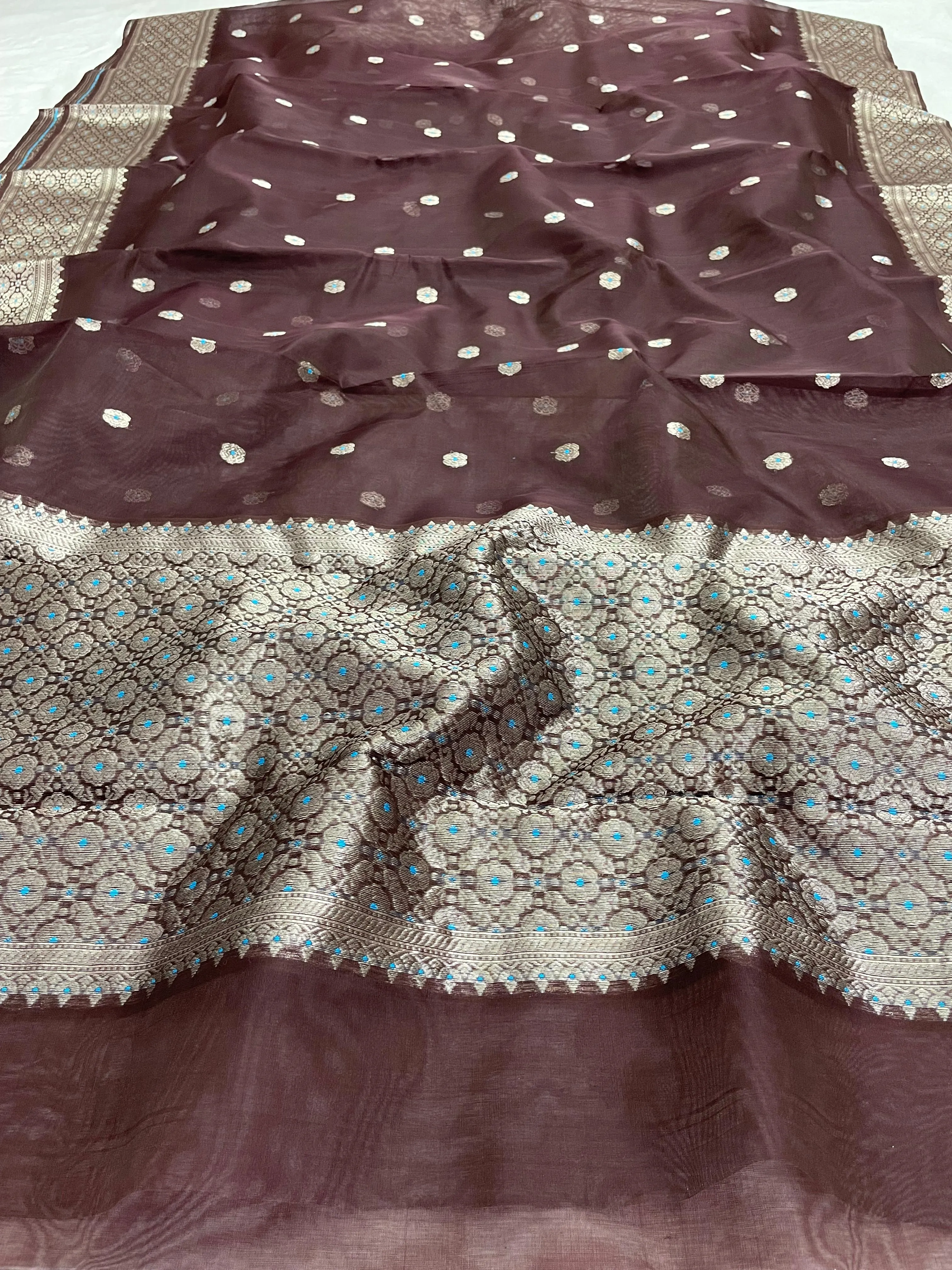 Golden beige handwoven Chanderi silk saree with intricate silver zari border and delicate floral motifs, ideal for weddings.