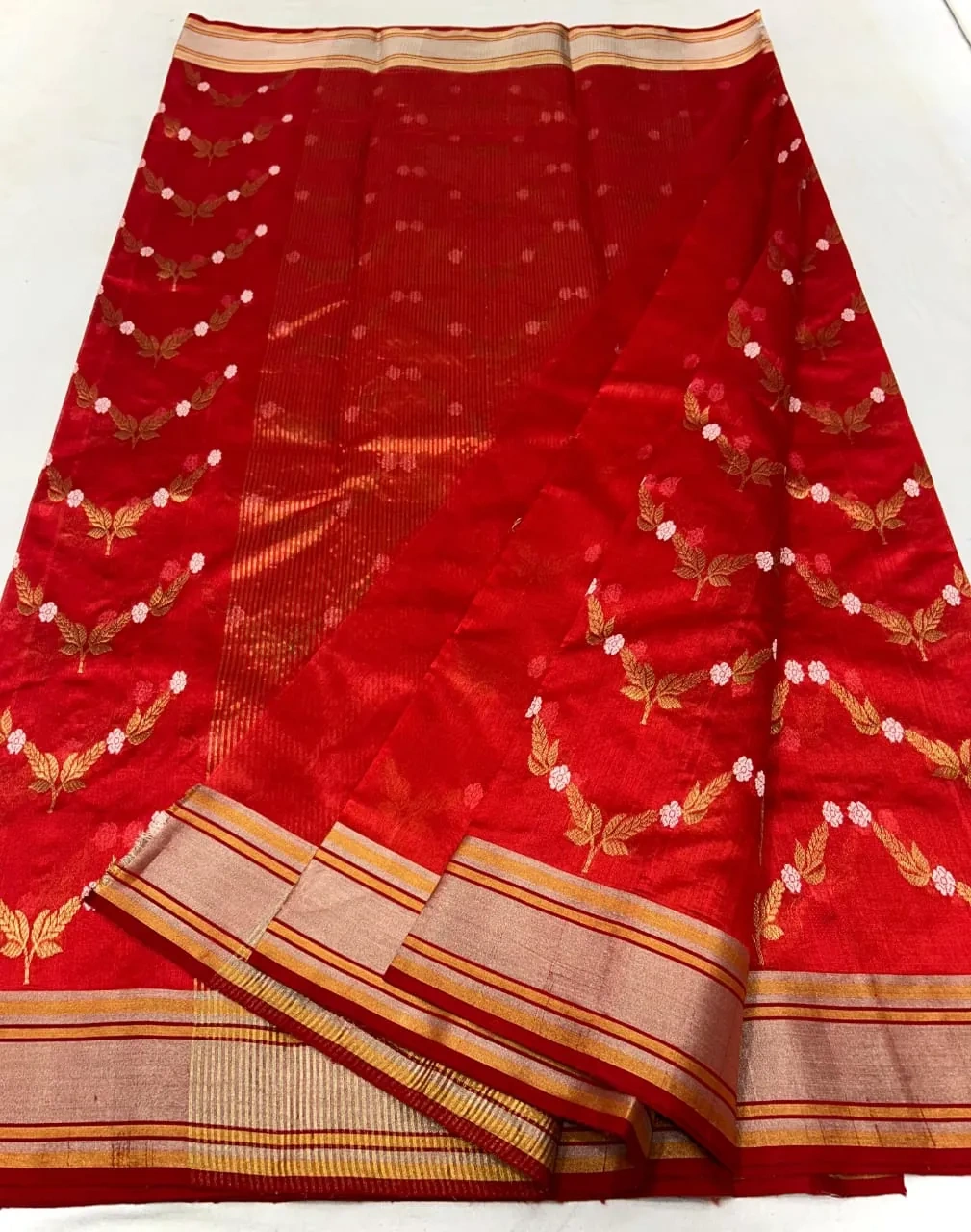 Handwoven Chanderi silk saree in rich red with gold zari border, floral motifs, and intricate woven patterns, elegant Indian attire