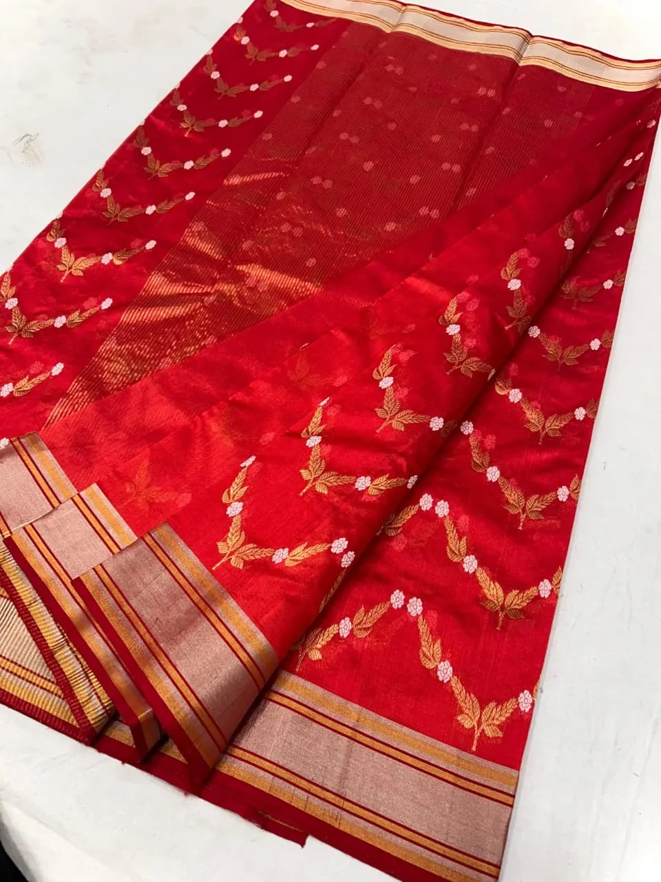 Handwoven Chanderi silk saree in vibrant red with gold zari border and floral motifs, elegant festive Indian attire