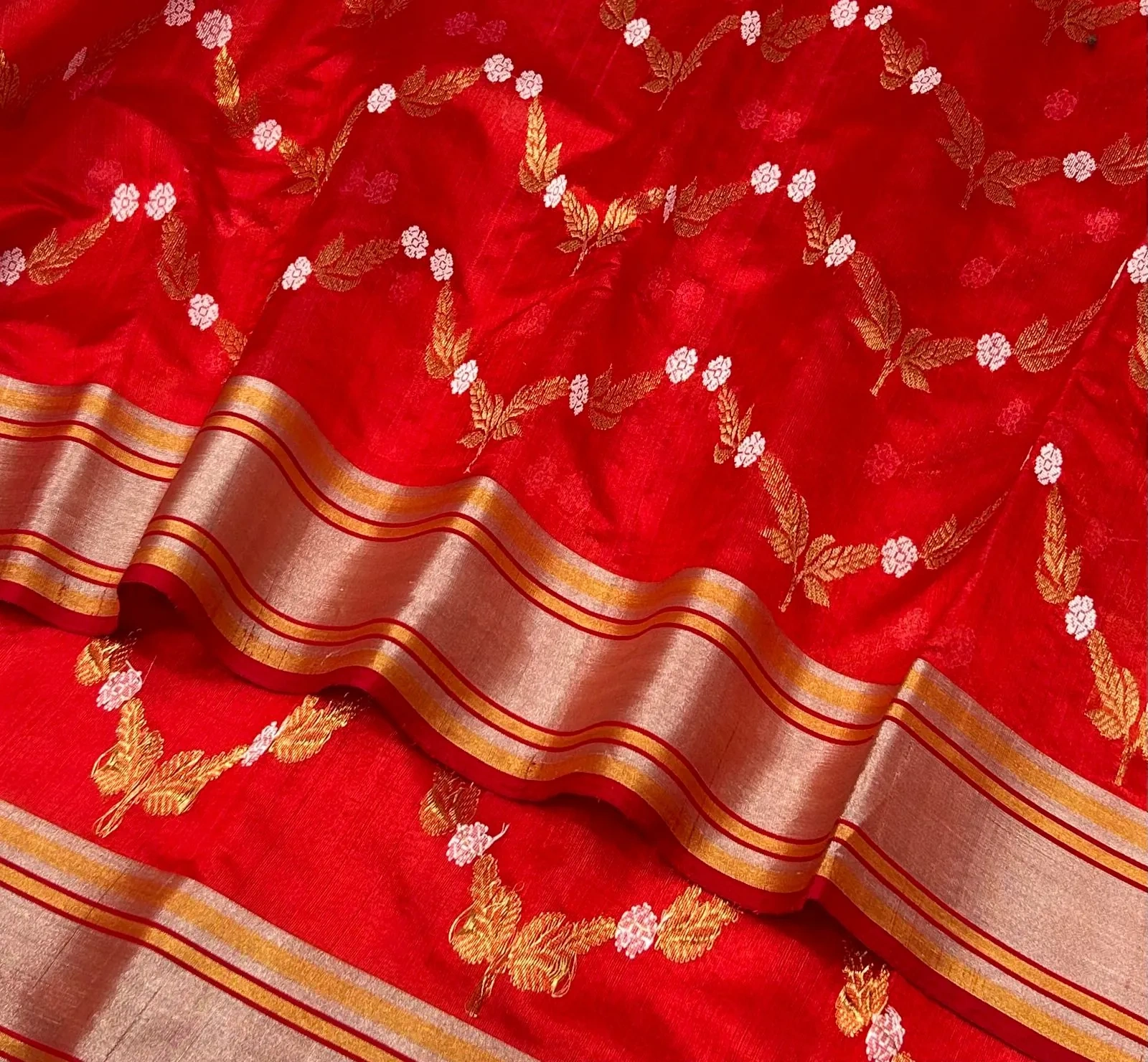 Handwoven Chanderi silk saree in vibrant red with gold zari floral motifs and a shimmering gold border, elegant festive wear