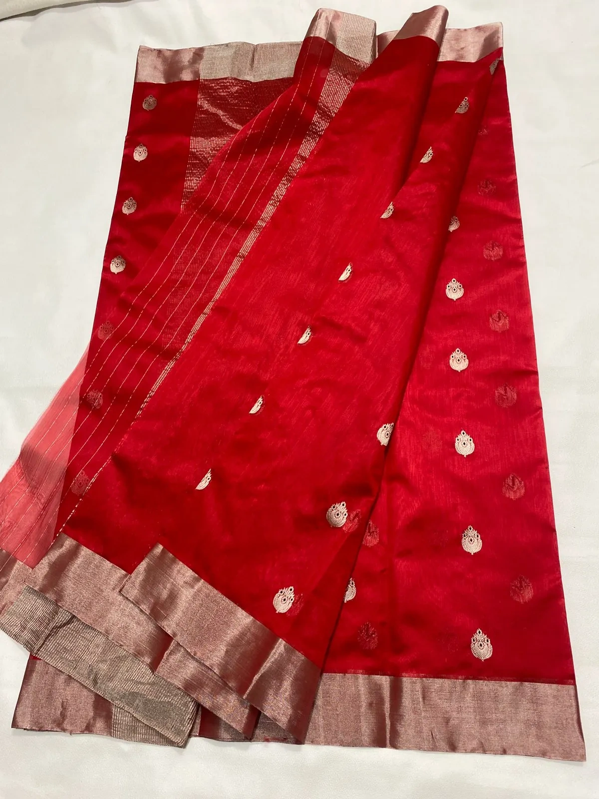 Handwoven pure Chanderi silk saree in rich red with gold zari motifs and a contrasting gold border, perfect for weddings.