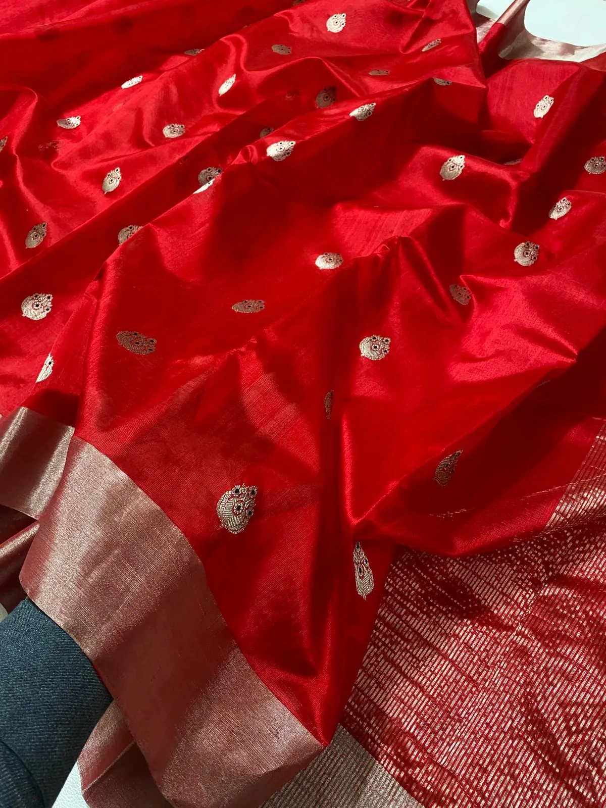 Handwoven pure Chanderi silk saree in vibrant red with gold zari motifs and a contrasting beige silk border, ideal for weddings.