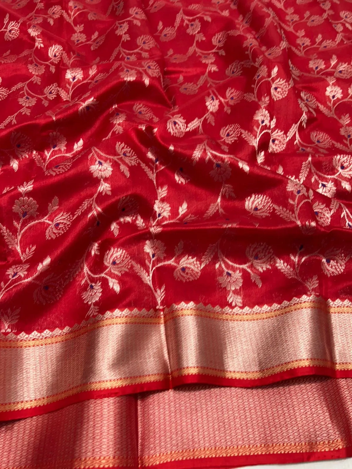Pure Chanderi silk saree in rich red with intricate gold zari floral embroidery and a contrasting gold border, ideal for weddings.