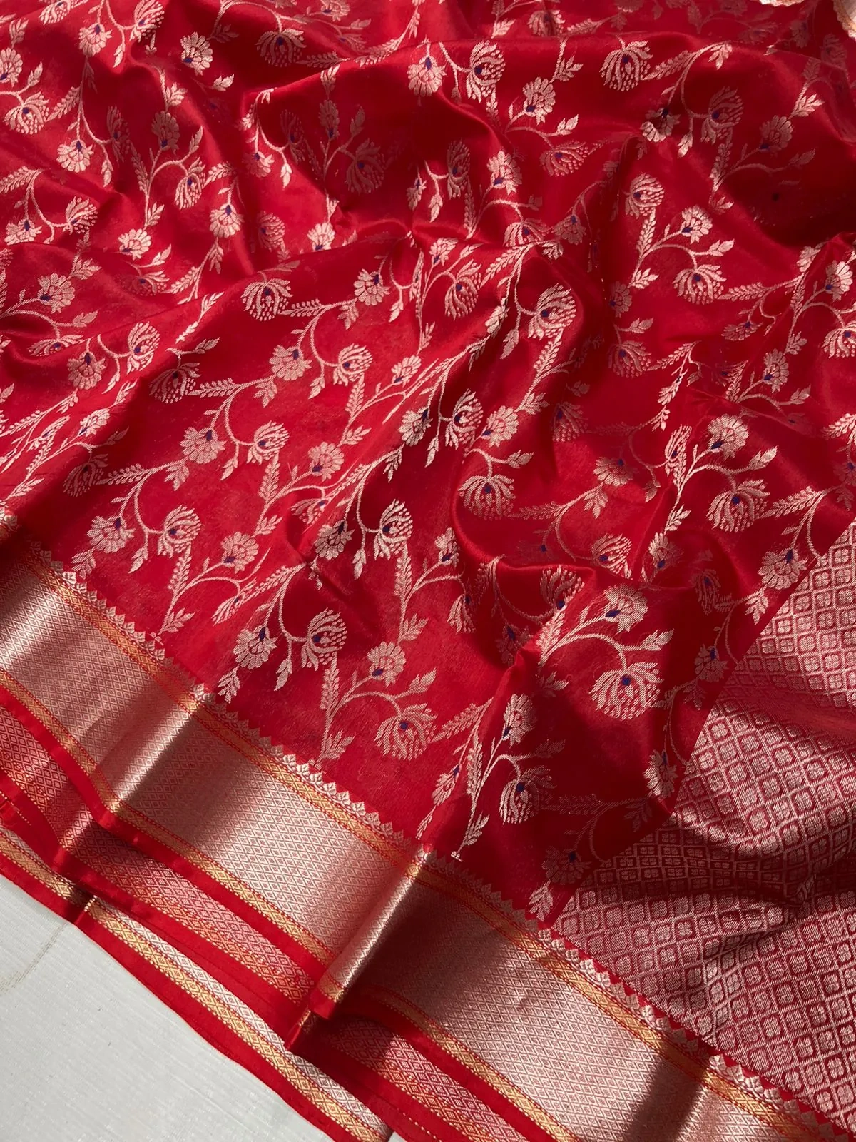 Pure Chanderi silk saree in rich red with intricate gold zari floral embroidery and a shimmering gold border, ideal for weddings.
