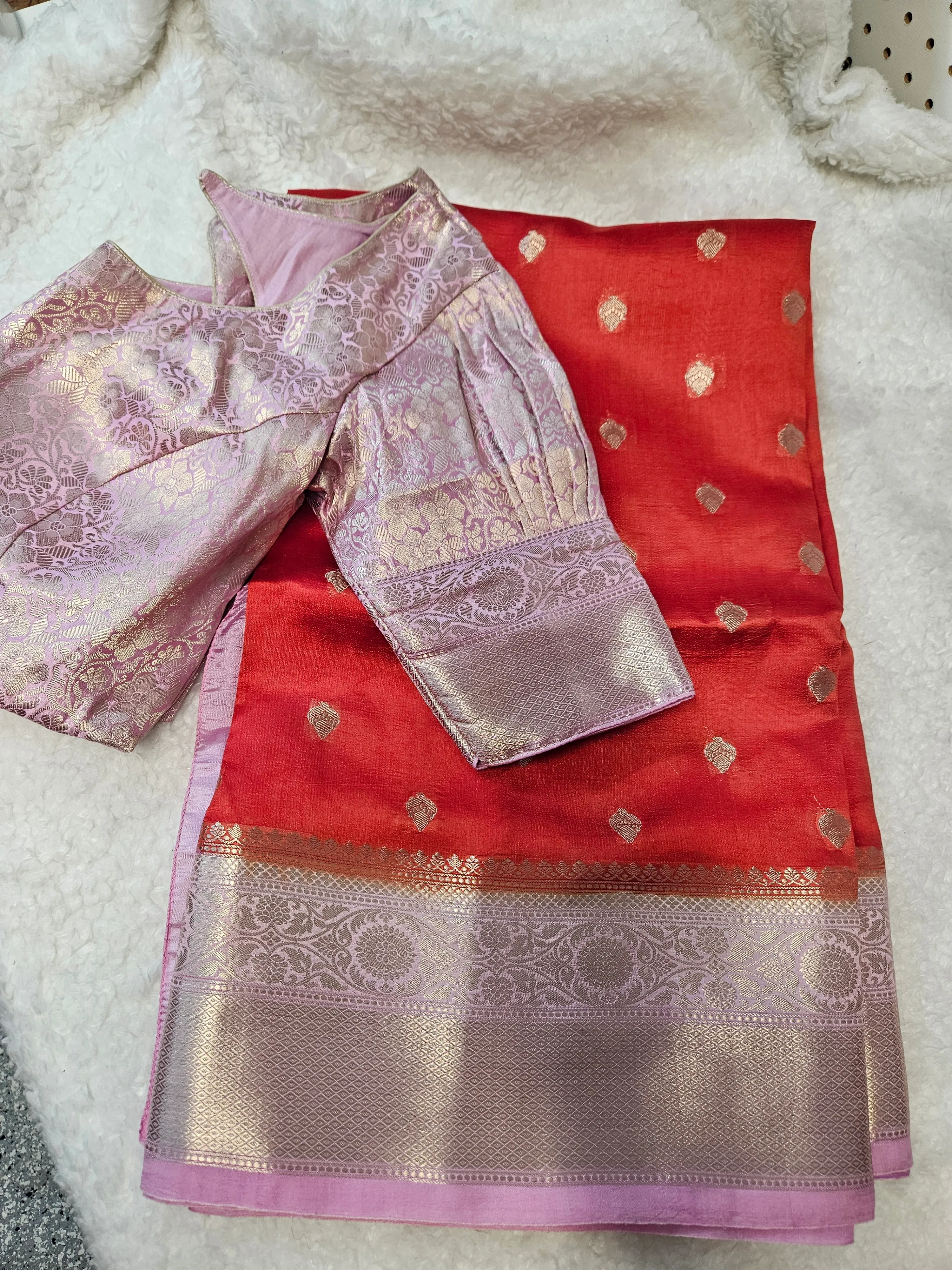 Handwoven pure raw mango silk saree in vibrant red with gold zari motifs, paired with a pink brocade blouse, ideal for bridal wear.