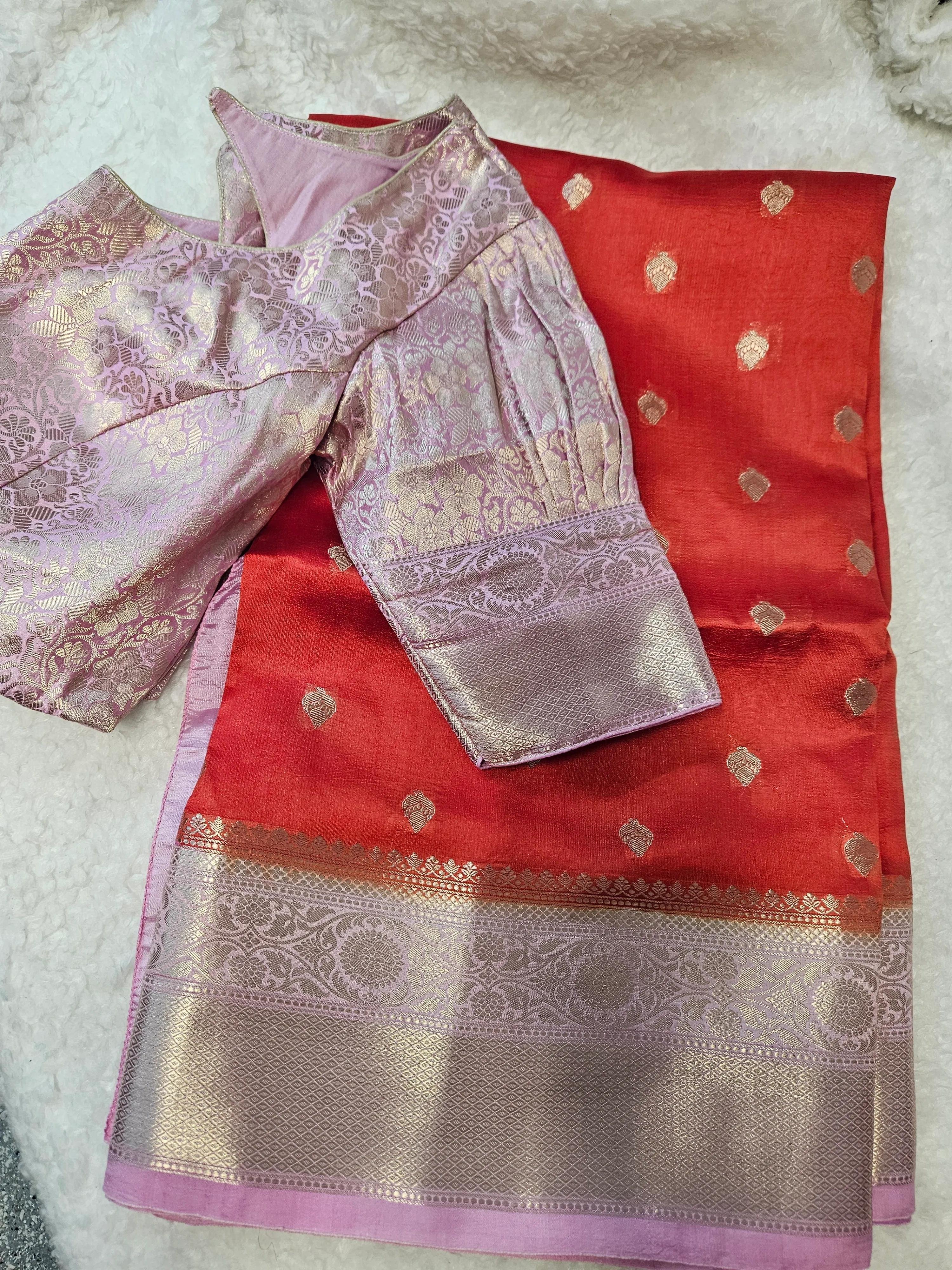 Handwoven pure raw mango silk saree in vibrant red with gold zari motifs, paired with a pink brocade blouse, ideal for bridal wear.