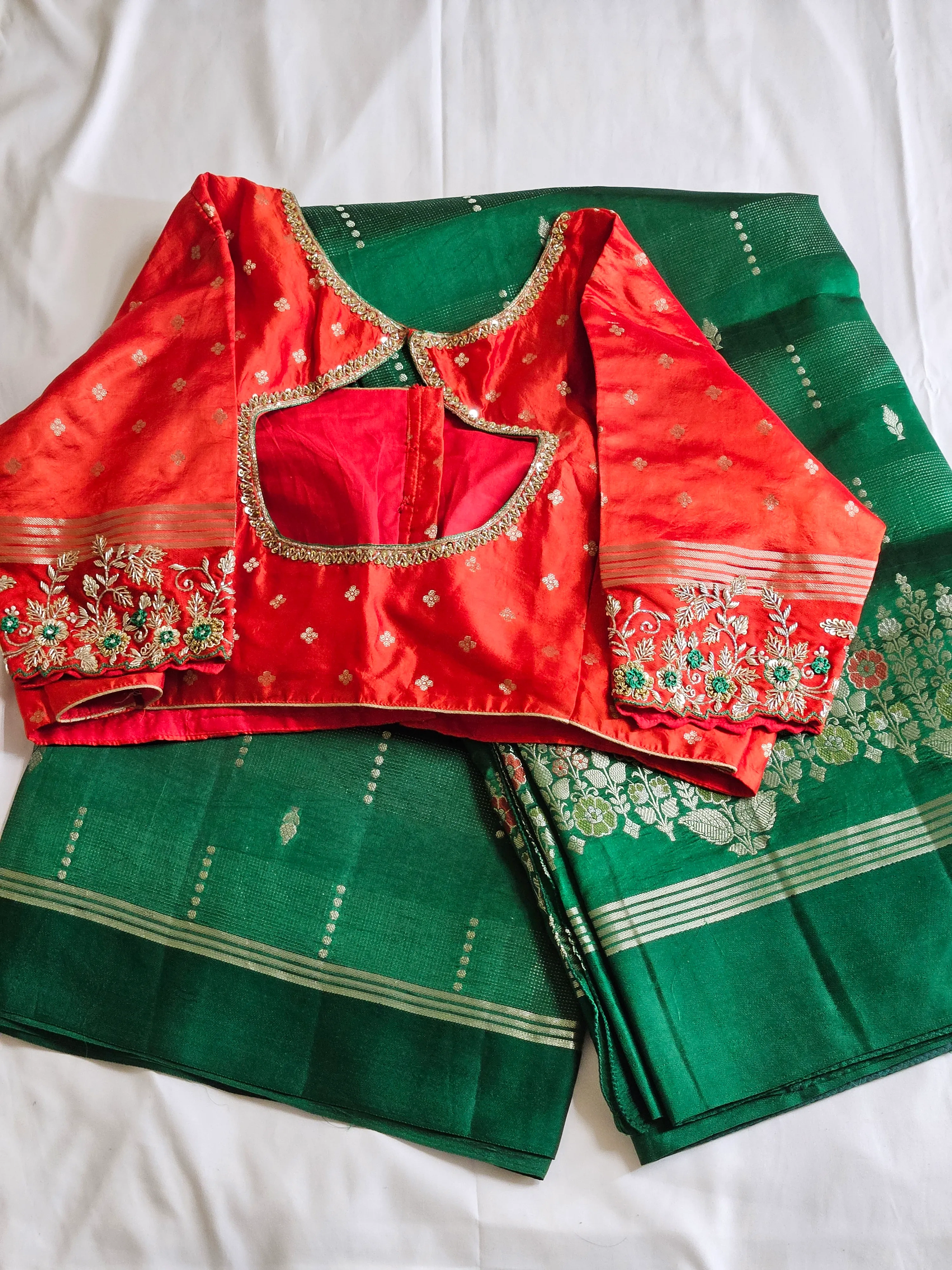 Handcrafted pure raw mango silk saree in deep green with silver zari border, paired with red embroidered blouse