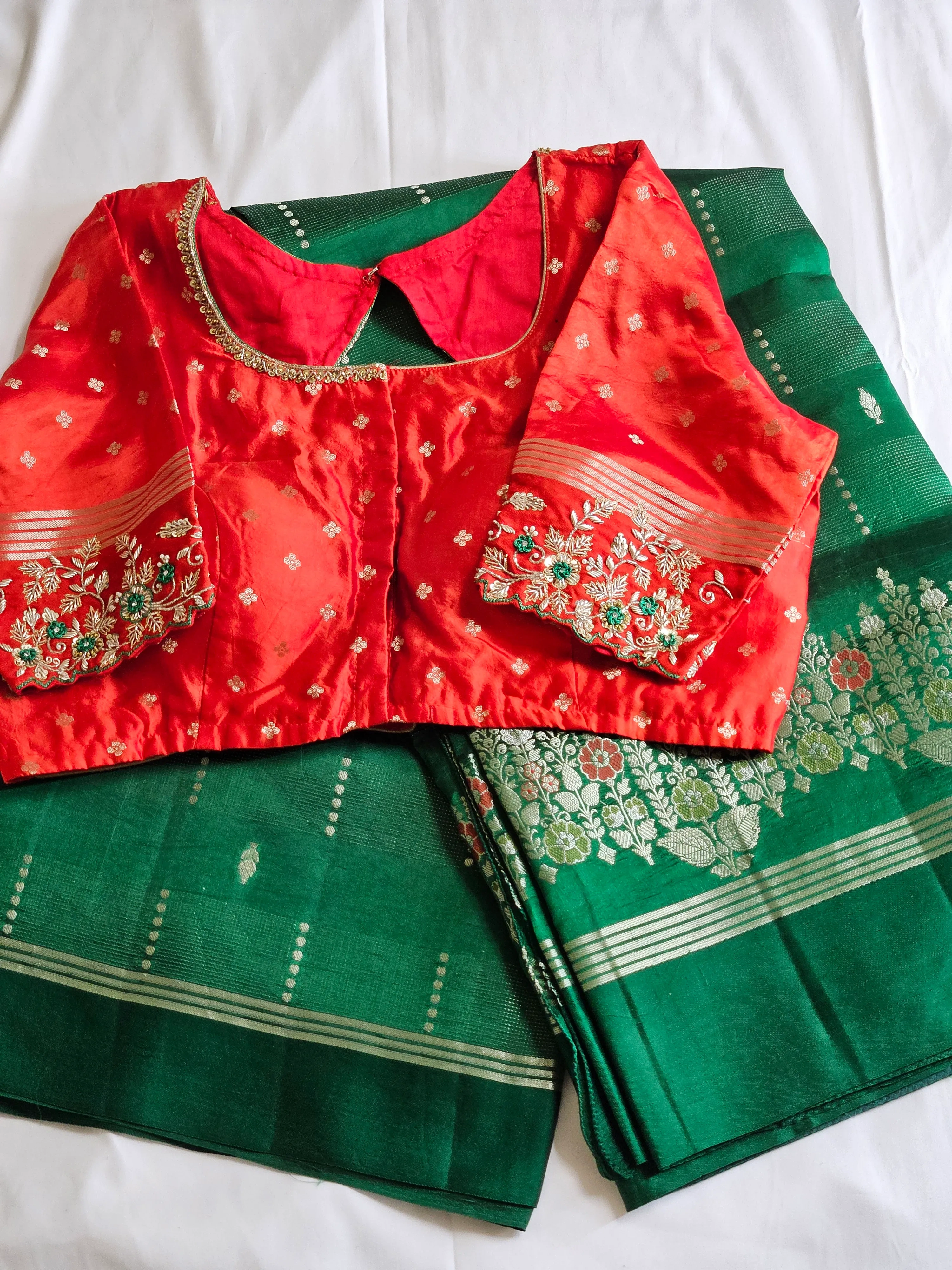 Handcrafted pure raw mango silk saree in deep green with gold zari motifs, paired with a red embroidered blouse