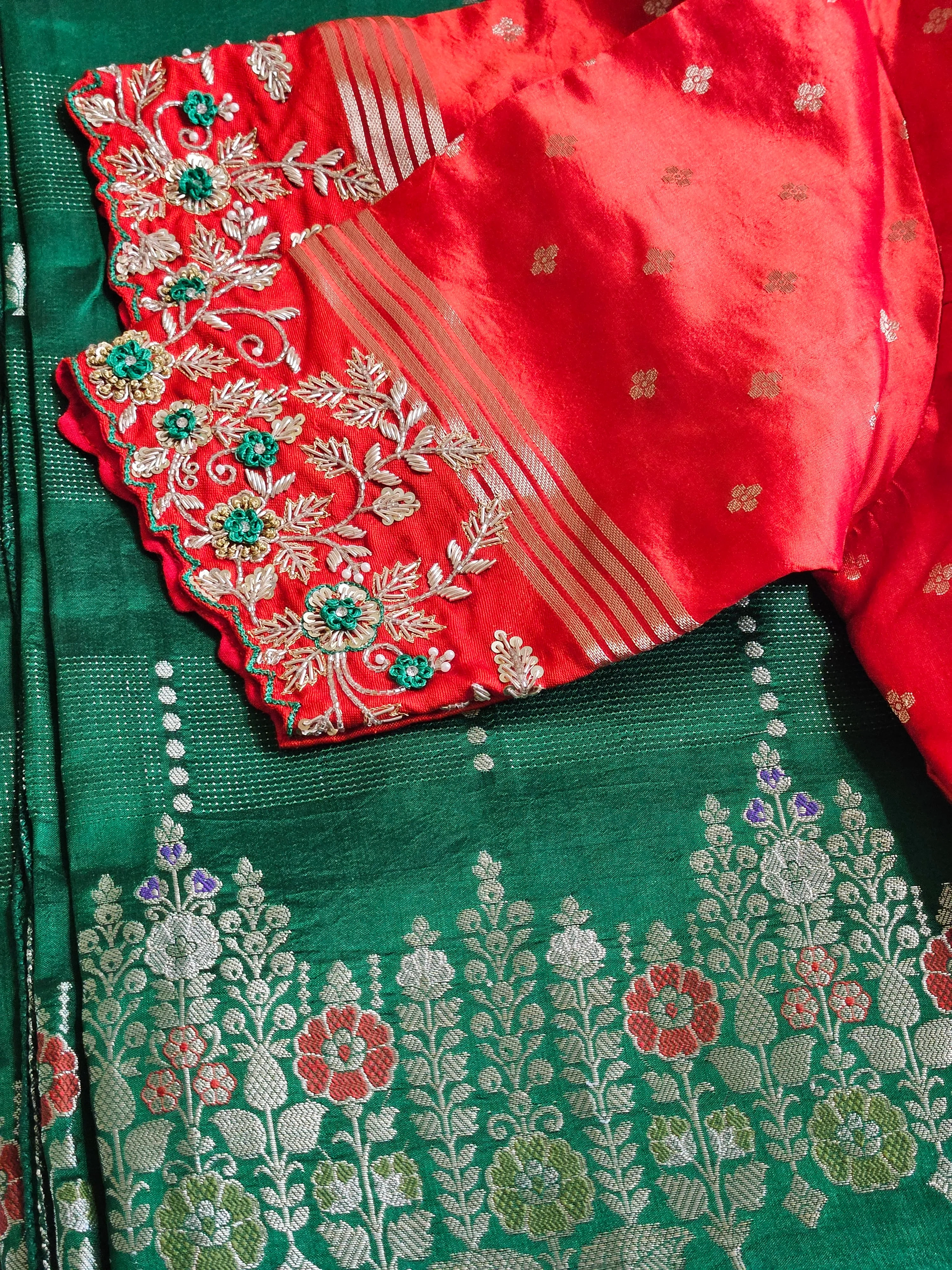 Handcrafted pure raw mango silk saree in vibrant green and red with intricate floral embroidery and gold zari accents