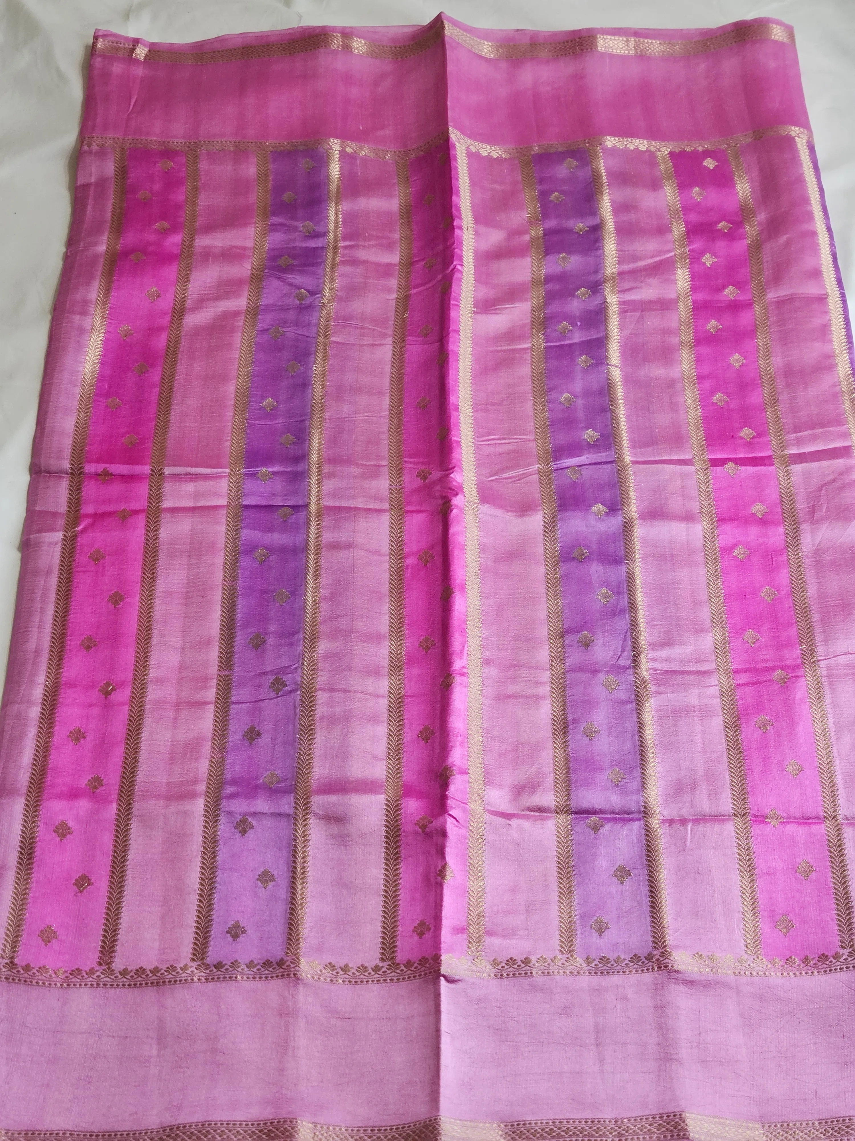 Handwoven pure raw mango silk saree in vibrant yellow with pink and purple ombre, gold zari borders, and festive motifs
