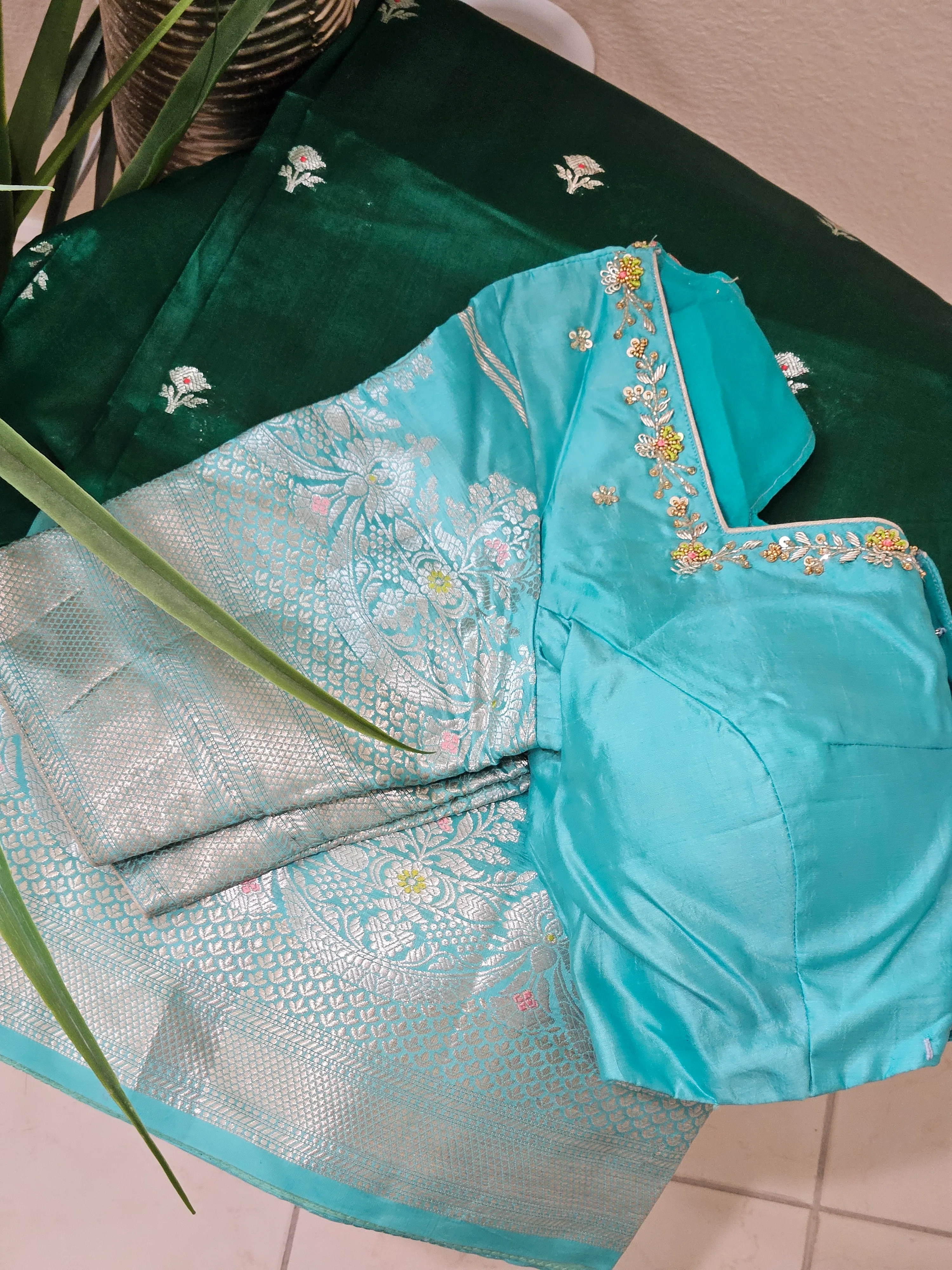 Handwoven pure raw mango silk saree in earthy yellow-green with intricate silver zari work, paired with an embroidered blouse.