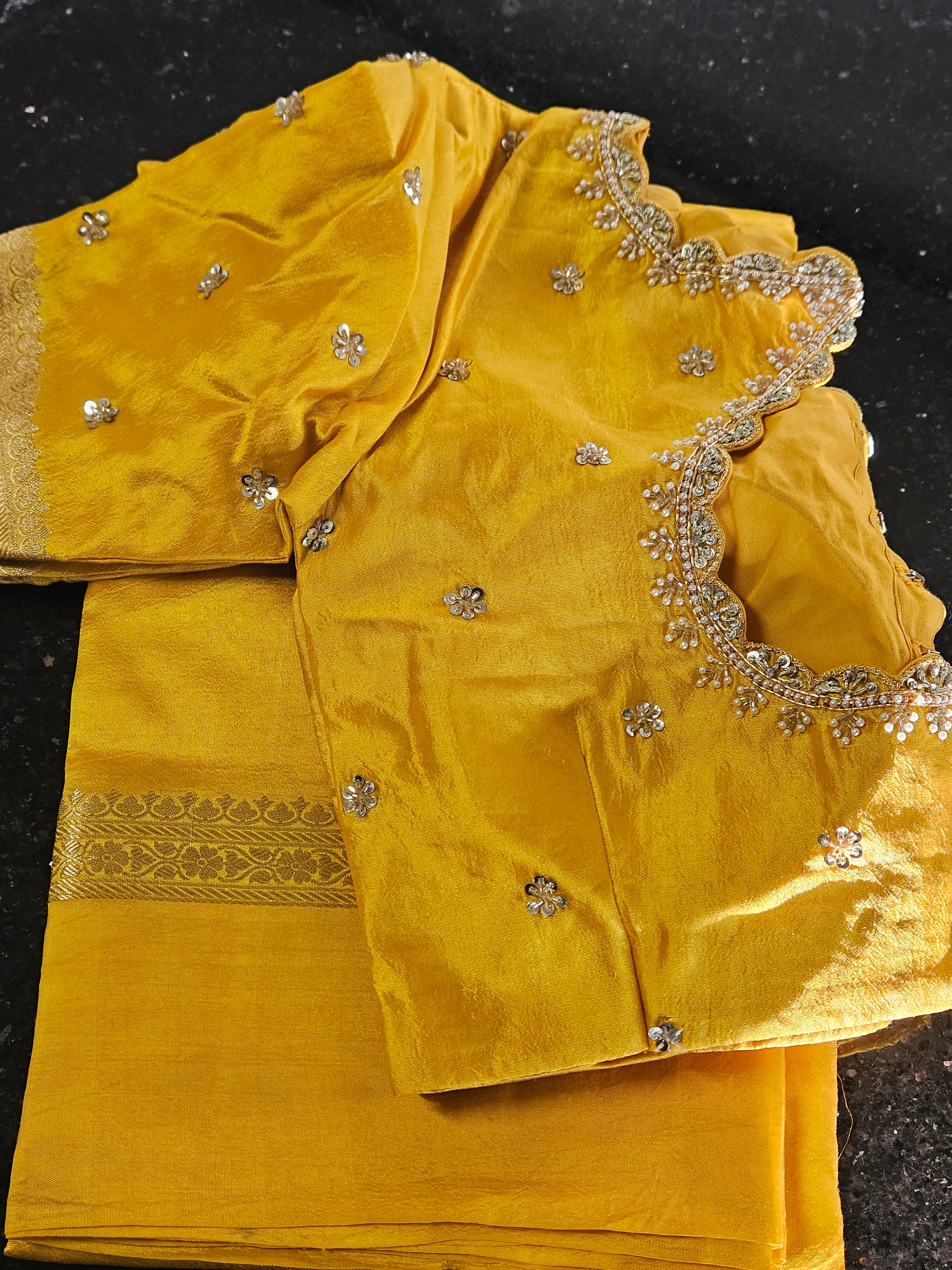 Pure raw mango silk saree in vibrant yellow with intricate silver floral embroidery and scalloped blouse, perfect for weddings.