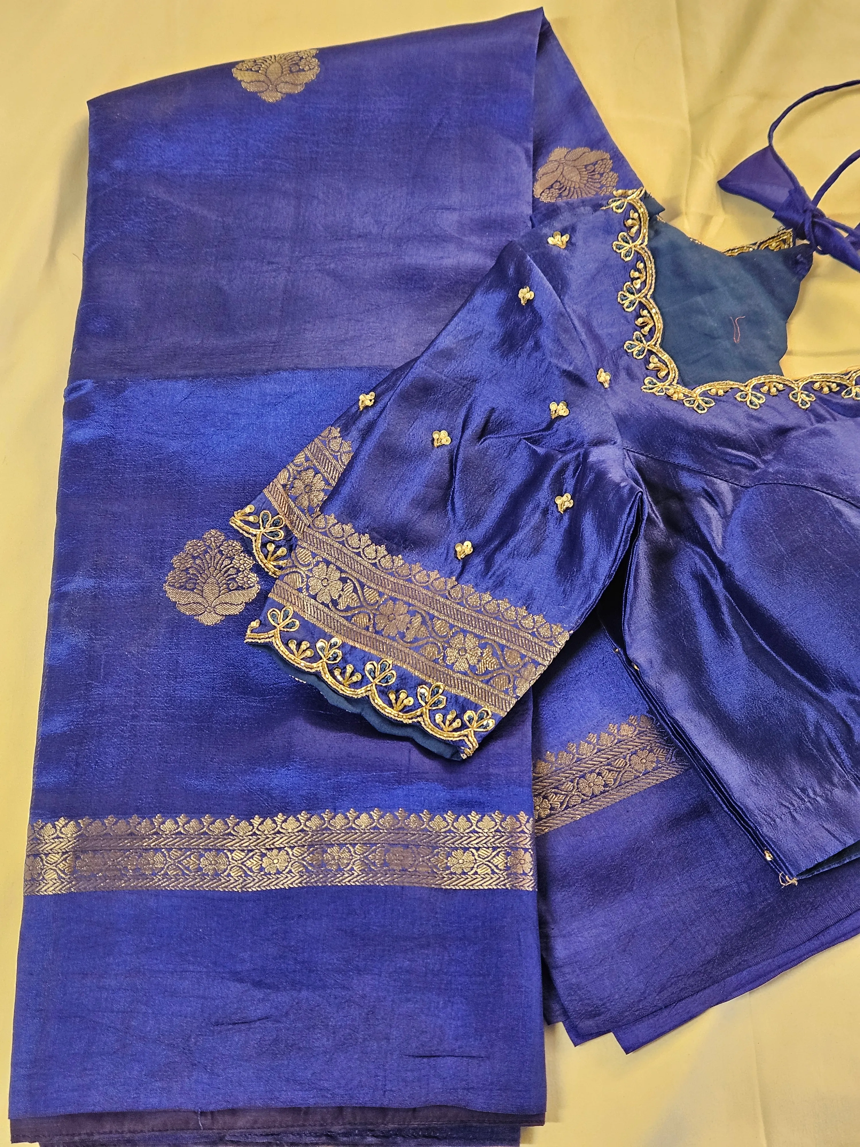 Handwoven pure raw mango silk saree in deep royal blue with gold zari floral motifs, paired with matching blouse for weddings.