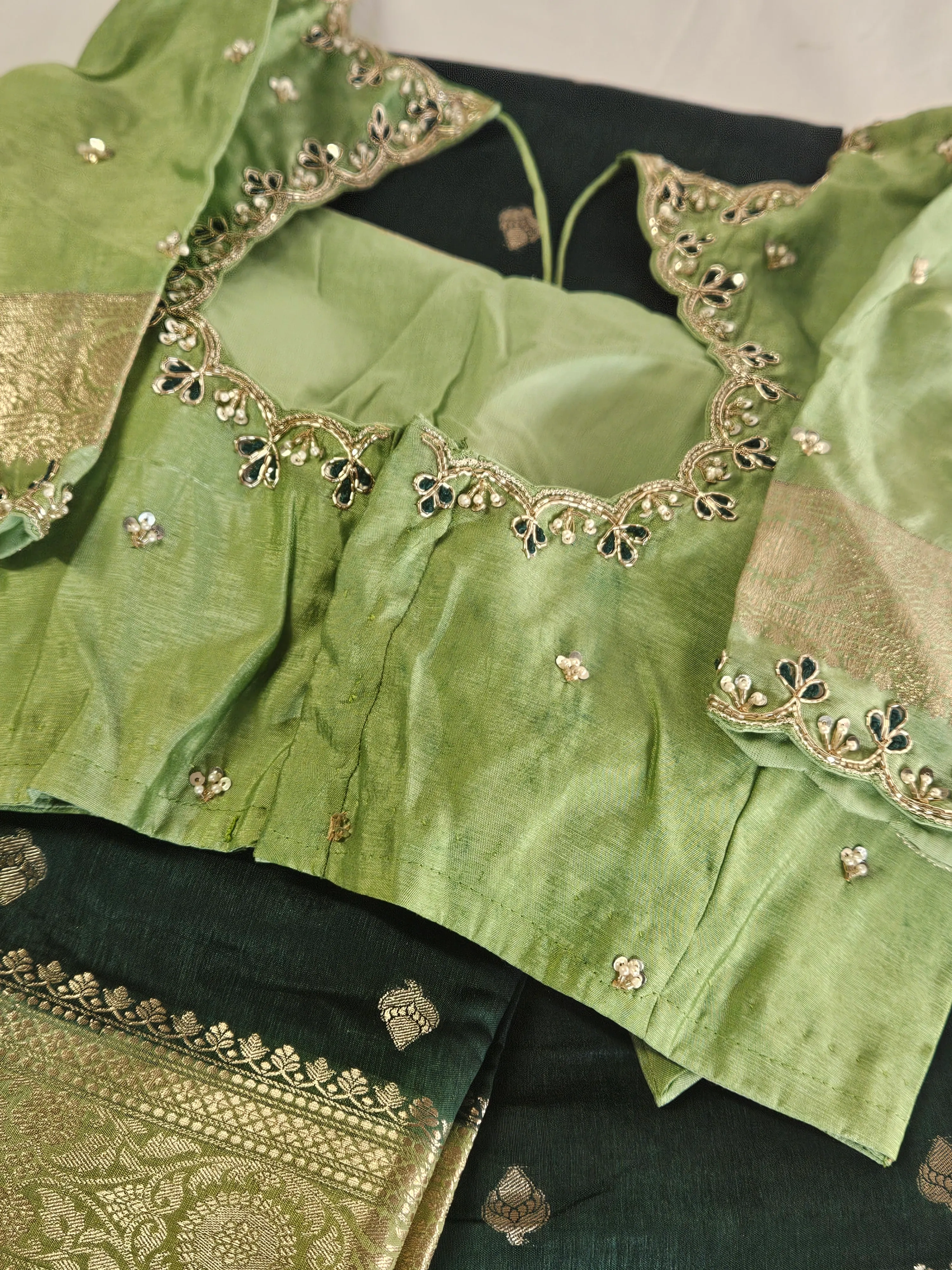 Handwoven pure raw mango silk saree in golden yellow with intricate zari border, paired with an embellished green blouse