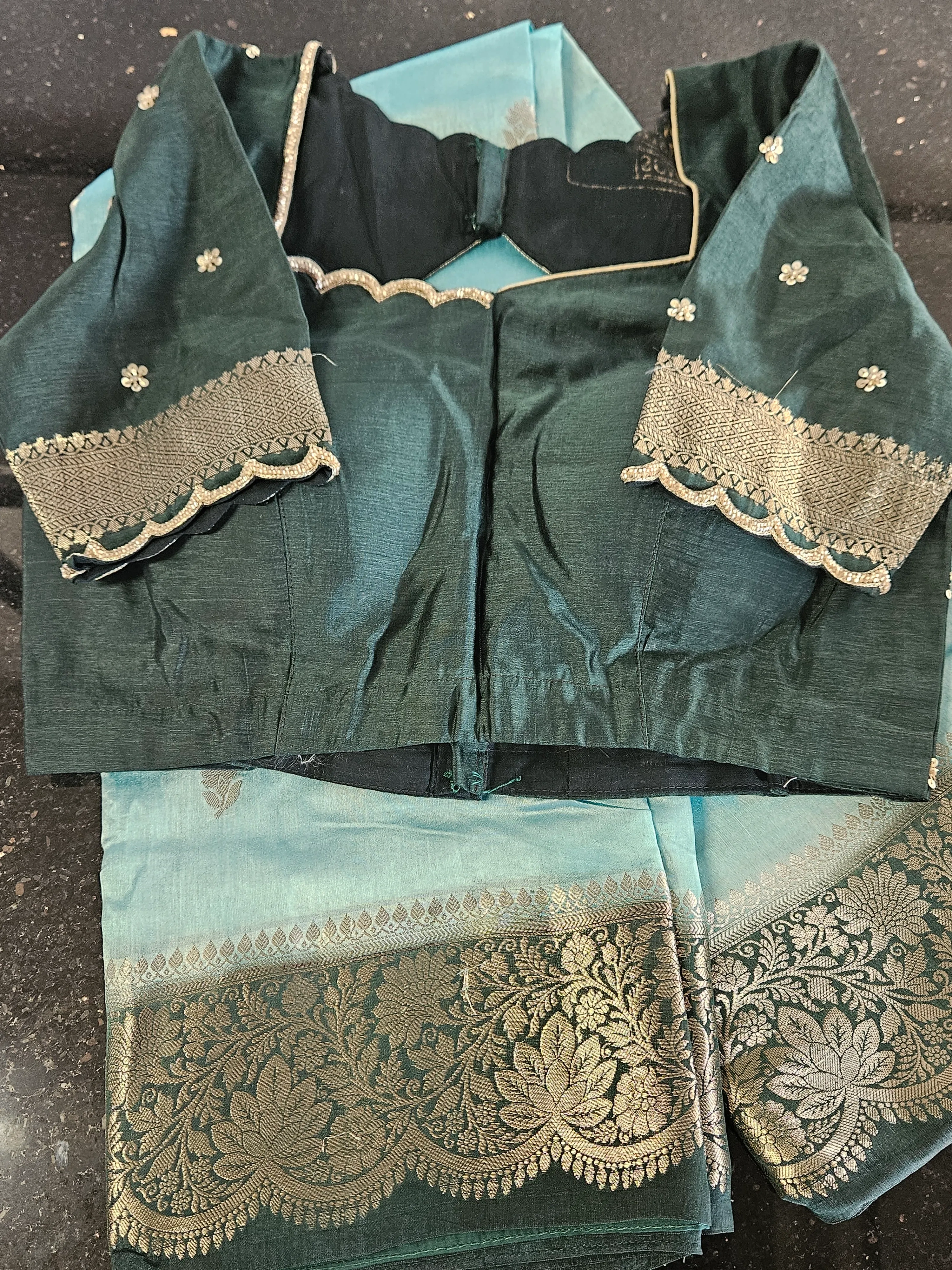 Handwoven pure raw mango silk saree in teal and aqua with gold zari floral border, paired with matching blouse.