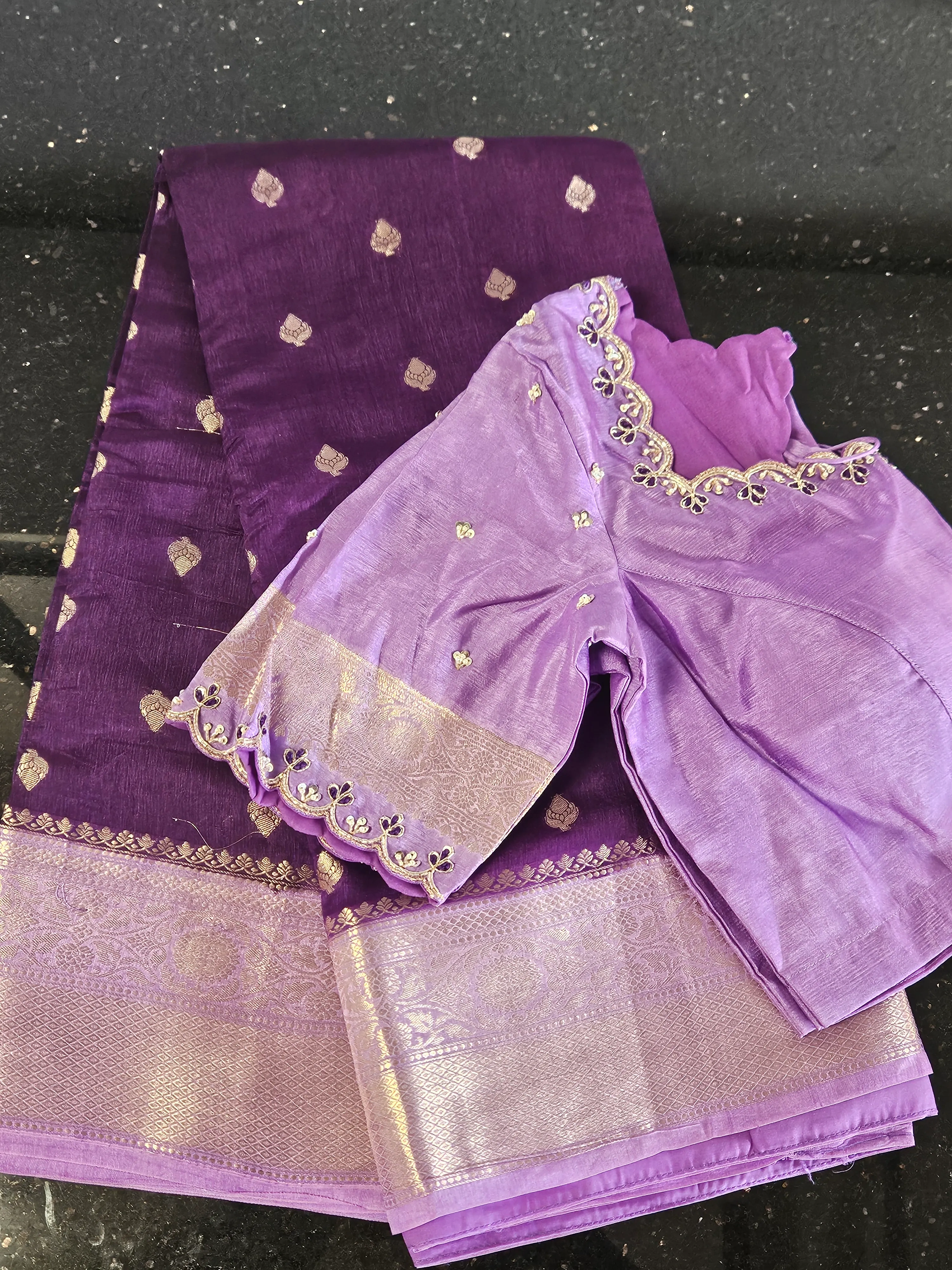 Handwoven purple raw silk saree with gold zari motifs and border, paired with a matching embroidered blouse piece.
