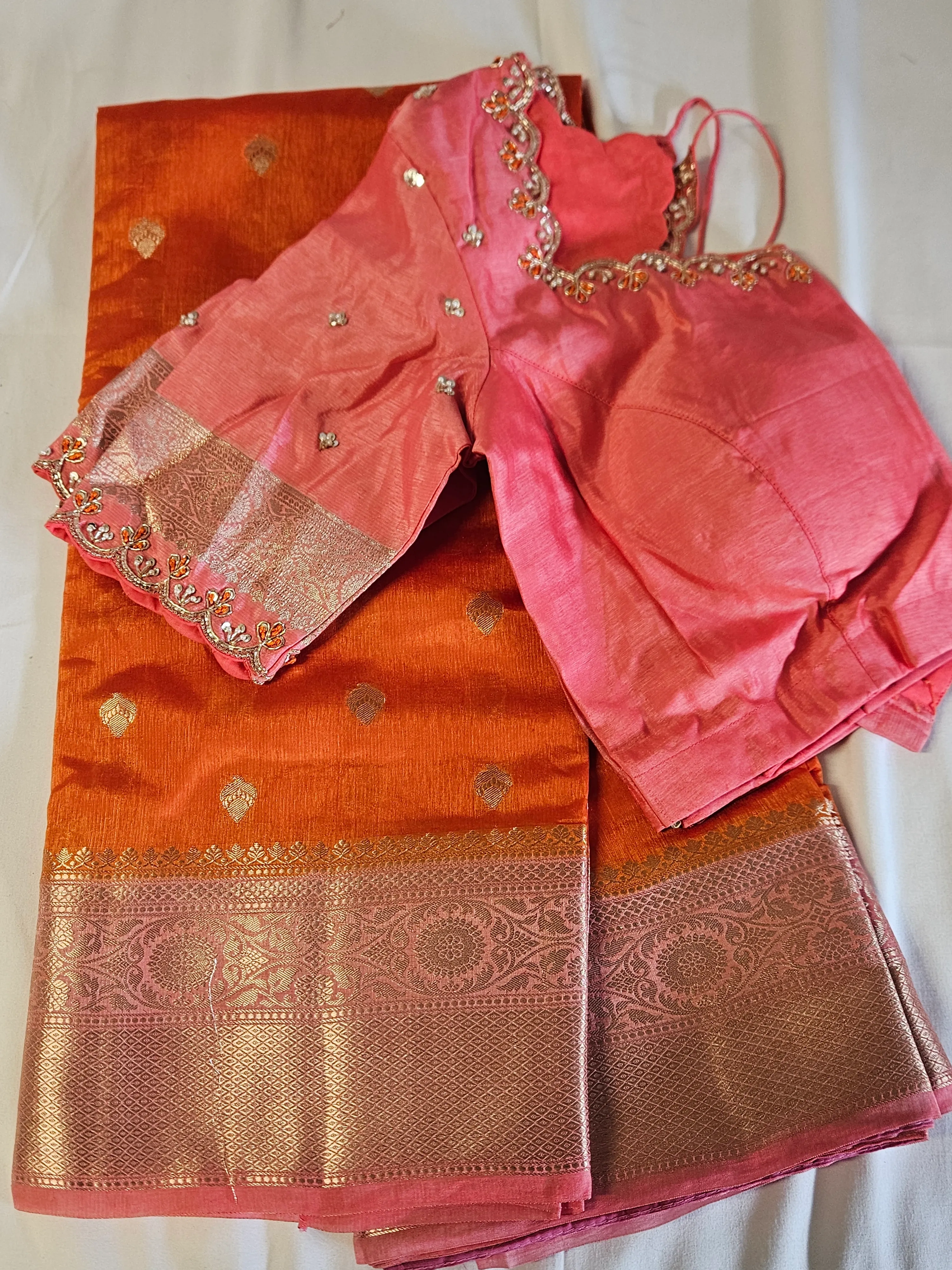 Golden yellow raw mango silk saree with intricate gold zari border, paired with a pink embroidered blouse, ideal for weddings.