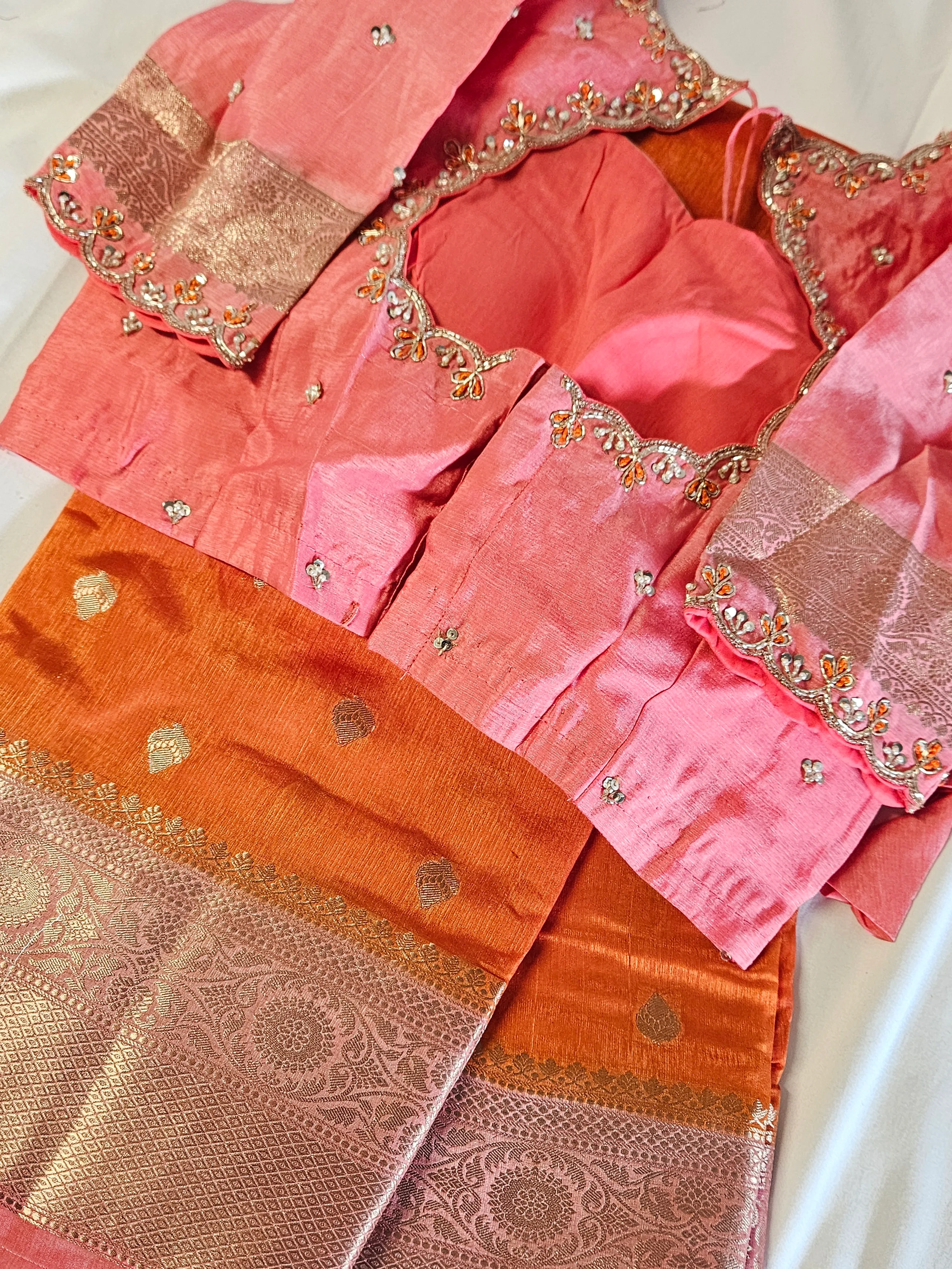 Golden yellow raw mango silk saree with intricate gold zari border, paired with an embellished pink blouse, perfect for weddings.