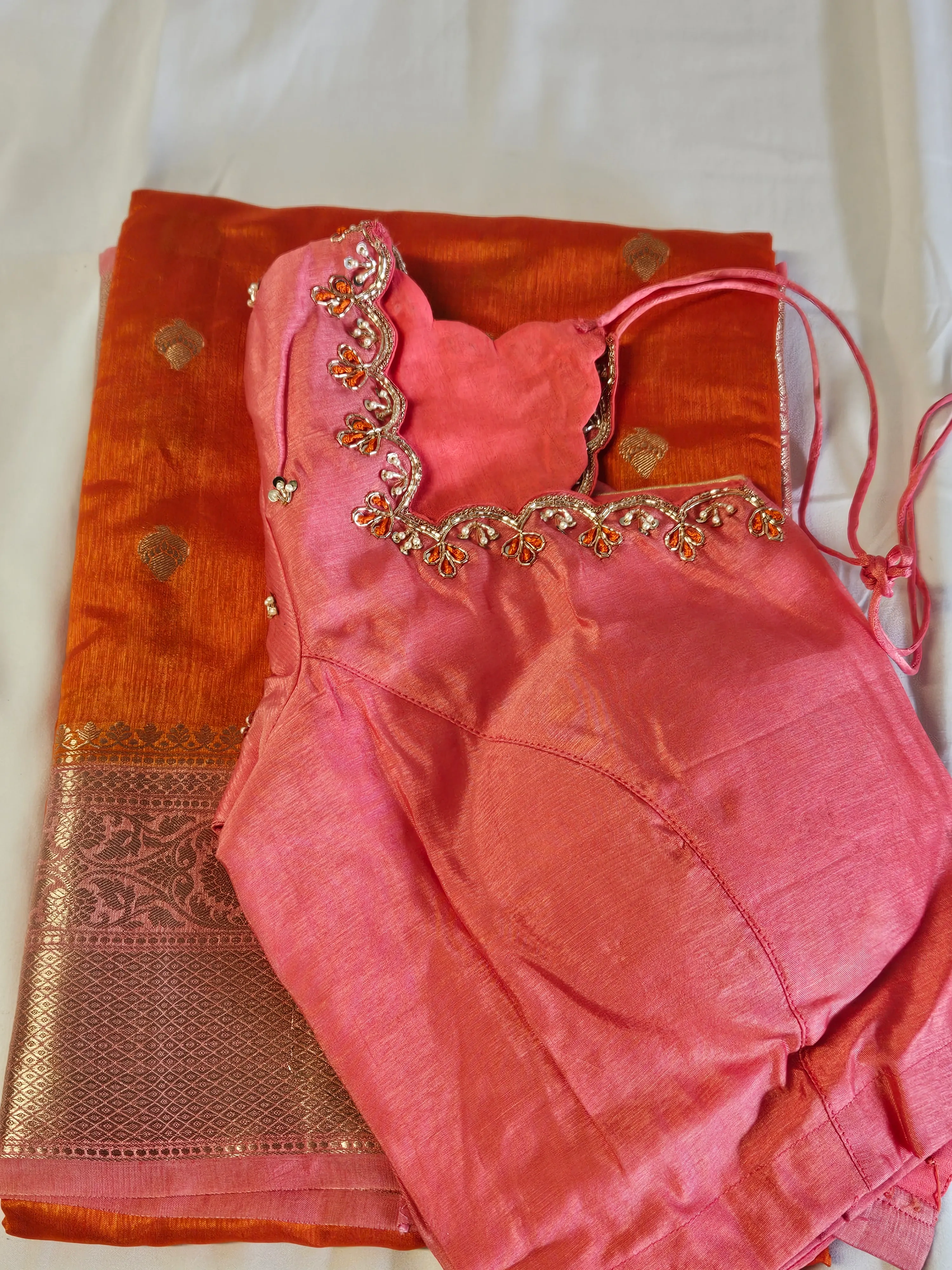 Golden yellow raw mango silk saree with intricate gold zari border, paired with an embellished pink silk blouse, ideal for weddings.