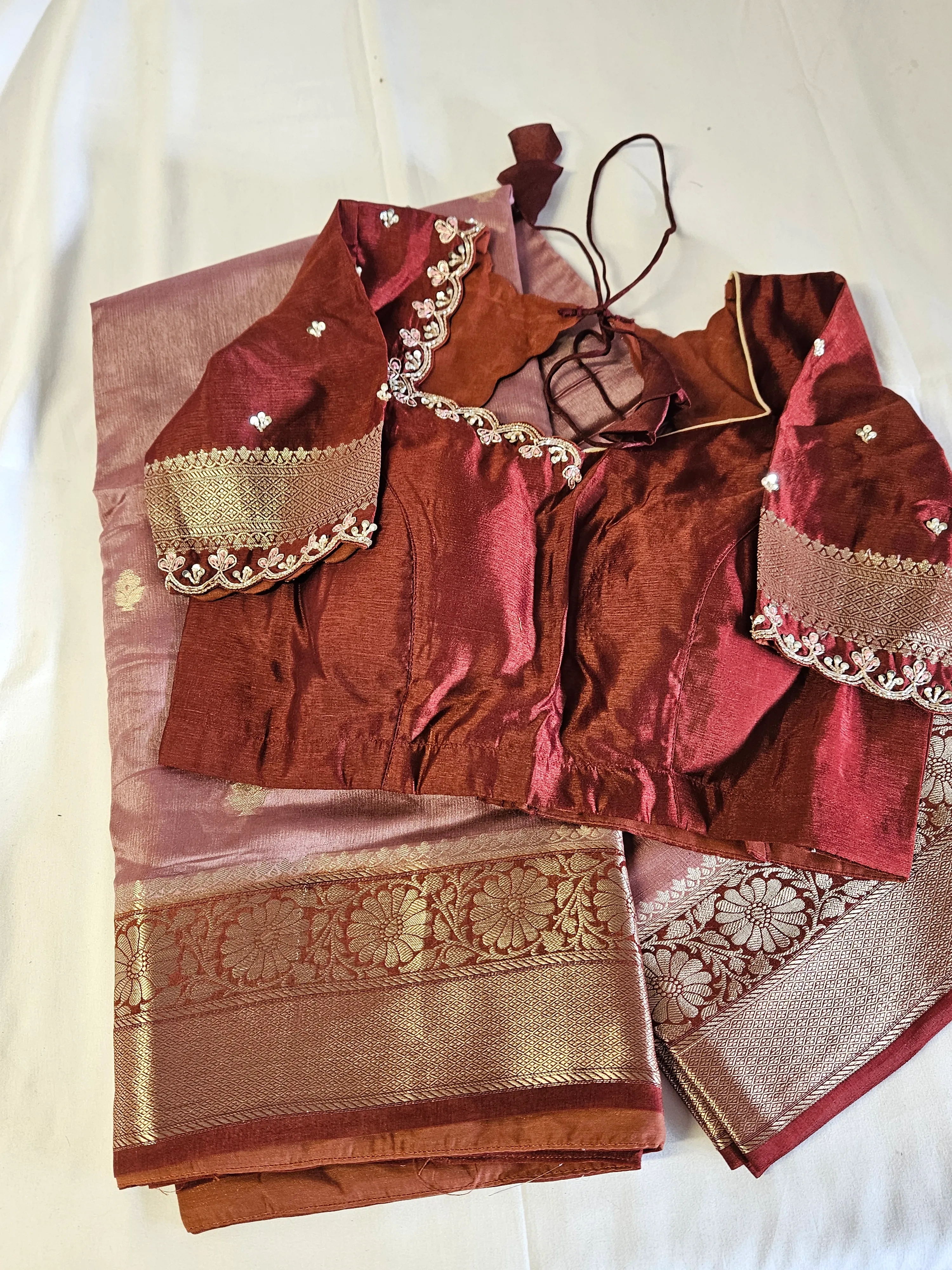Handwoven pure raw mango silk saree in earthy brown tones with gold zari border, paired with embroidered blouse