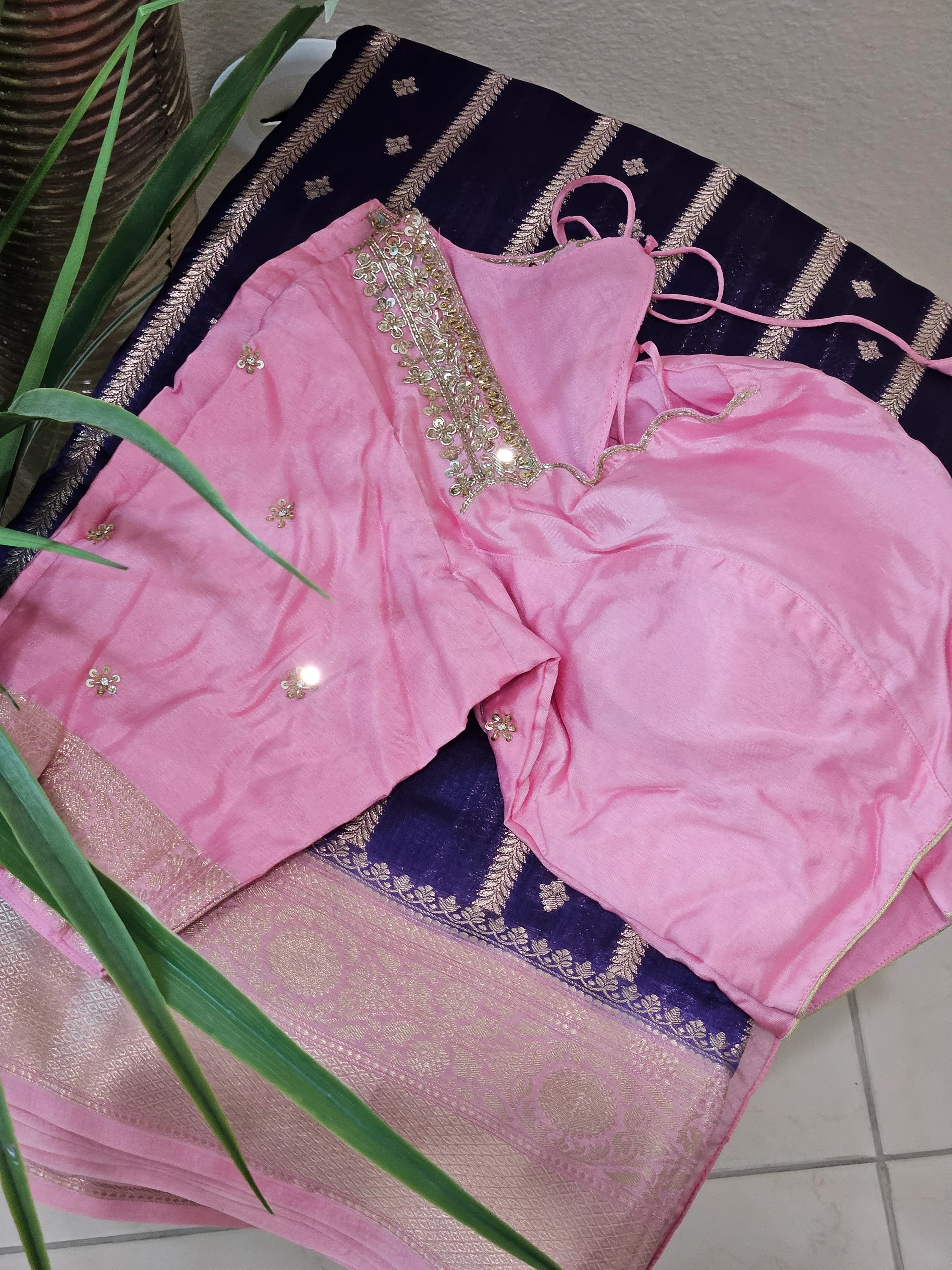 Handcrafted pure raw mango silk saree in deep navy blue with gold zari border, paired with pink embellished blouse.