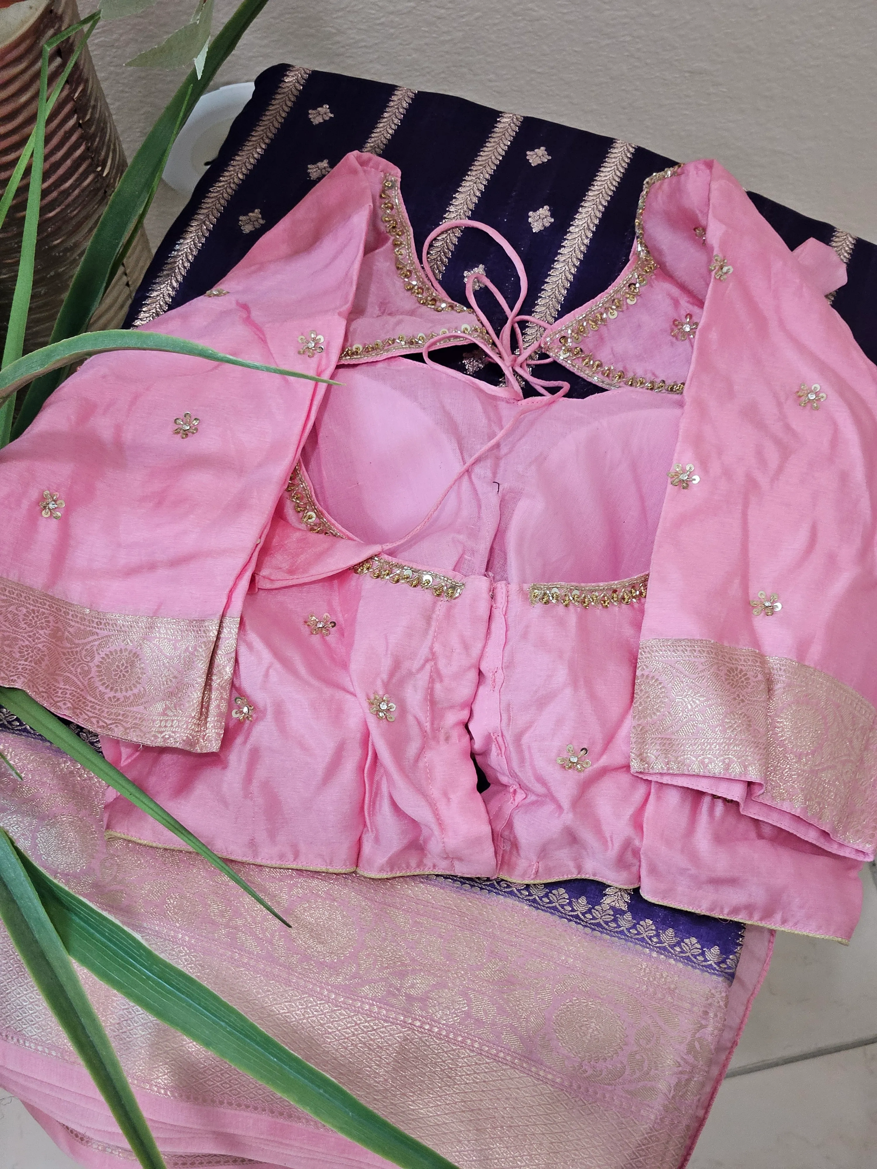 Handcrafted pure raw mango silk saree in soft pink with gold zari border and matching embellished blouse, ideal for weddings.