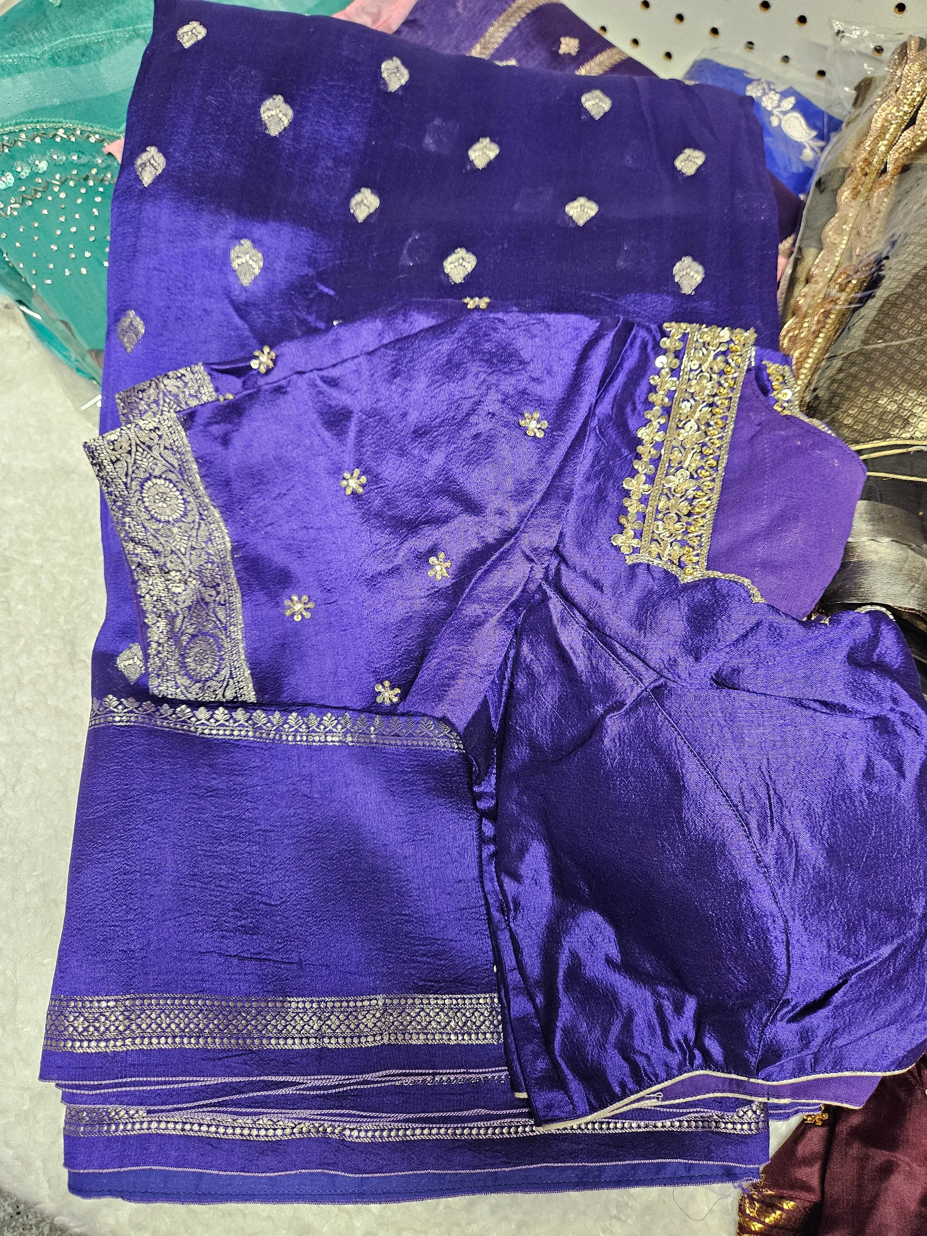 Handcrafted pure raw mango silk saree in royal blue with silver zari borders and delicate floral embroidery, ideal for weddings and parties.