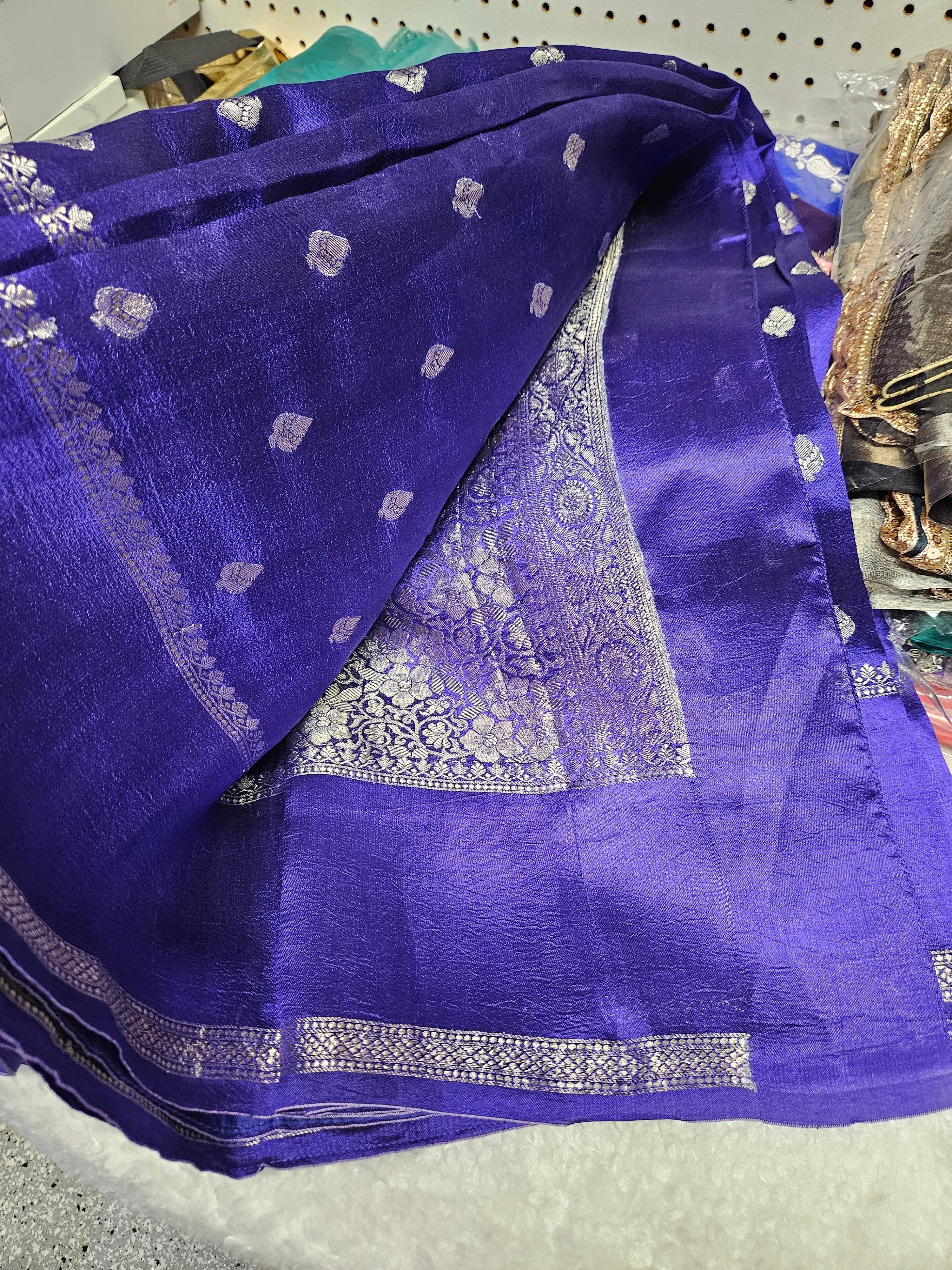 Handcrafted pure raw mango silk saree in rich royal blue with silver zari floral motifs and intricate border detailing.