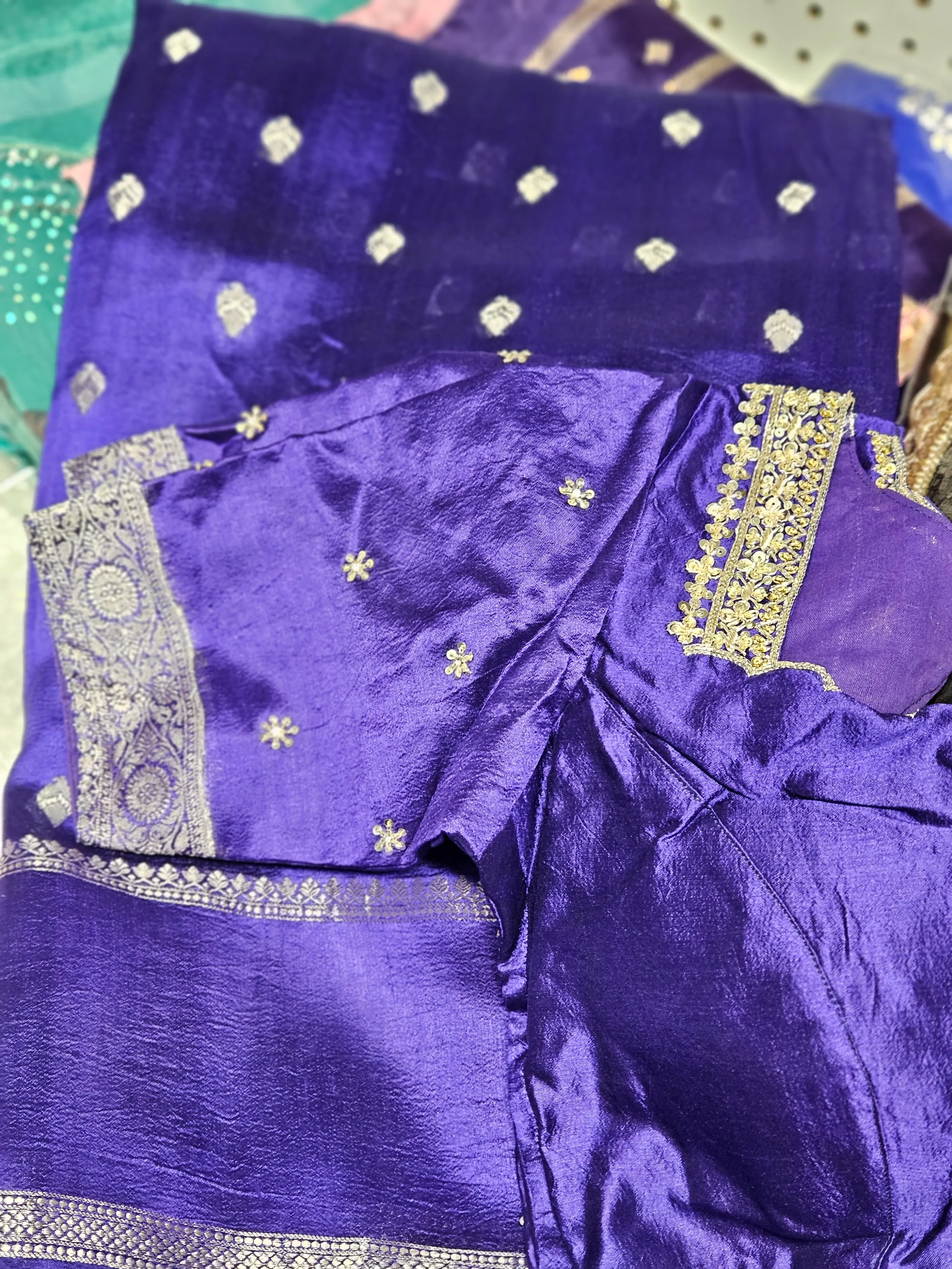 Handcrafted pure raw mango silk saree in rich purple with intricate silver zari borders and delicate embroidered motifs.