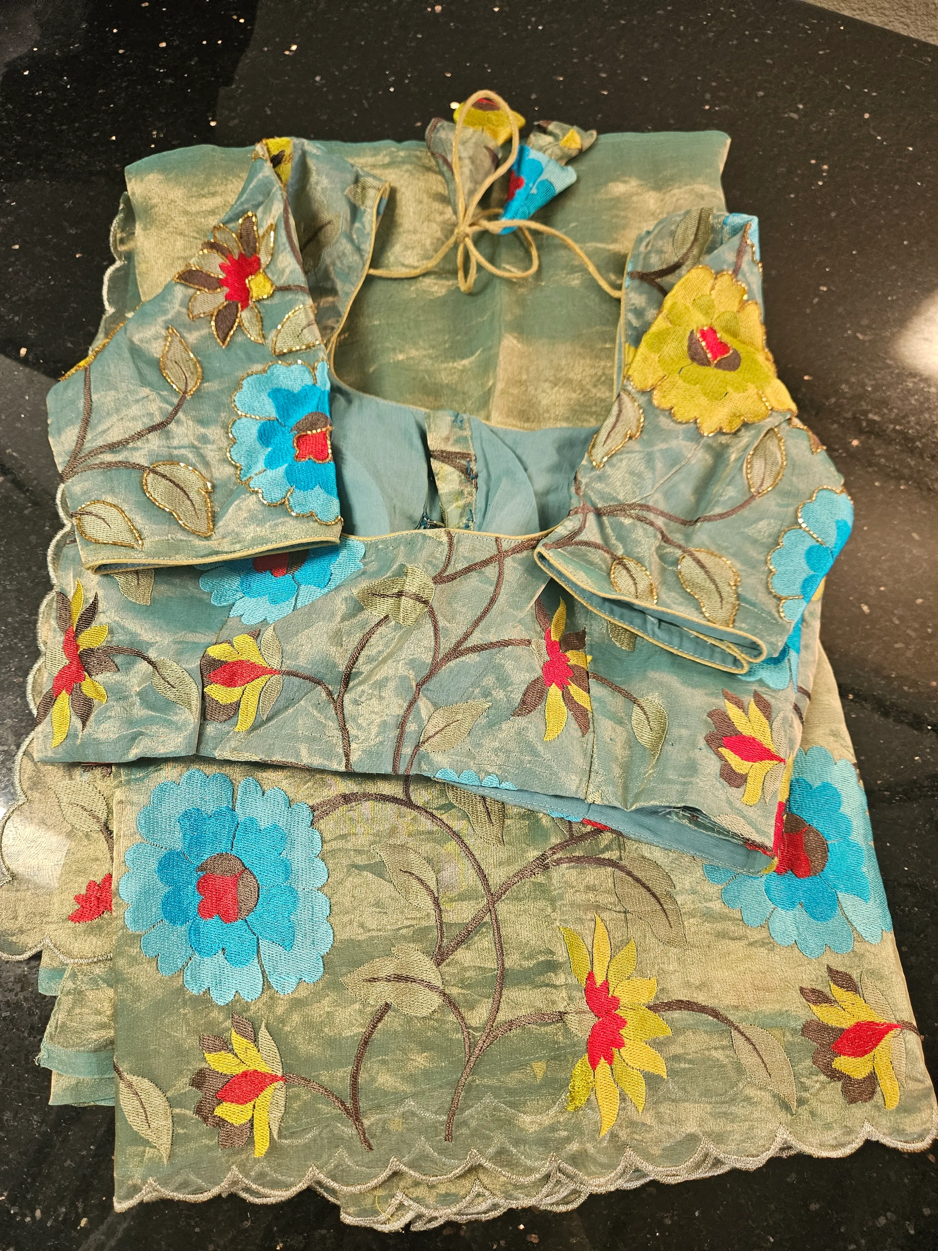 Handwoven pure Banarasi tissue saree in gold with colorful floral embroidery, scalloped border, and matching blouse.