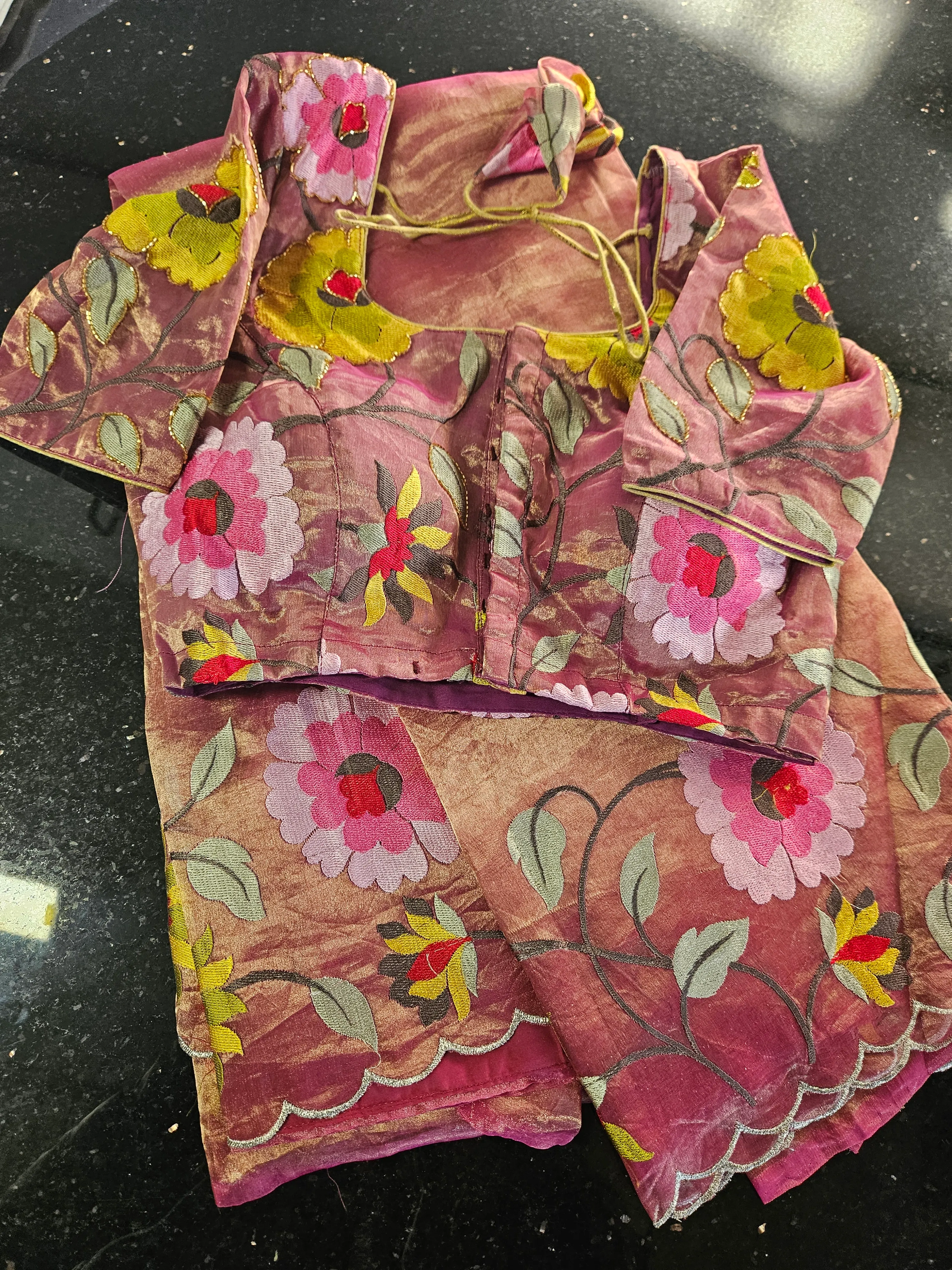 Handwoven golden Banarasi tissue silk saree with intricate floral zari embroidery, paired with matching blouse.