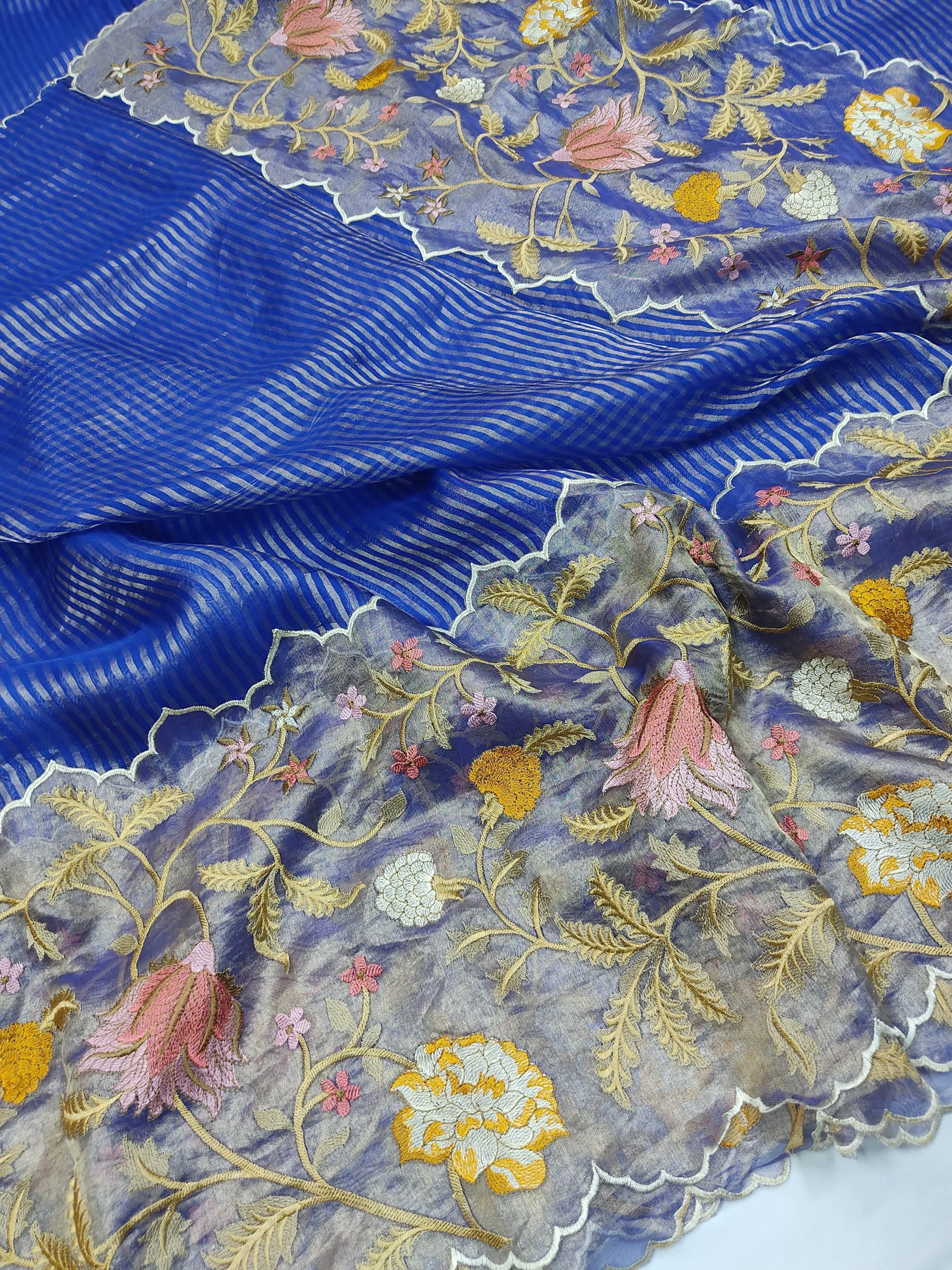 Handwoven pure Banarasi Kora tissue silk saree in royal blue with gold zari stripes and floral embroidery, ideal for weddings.
