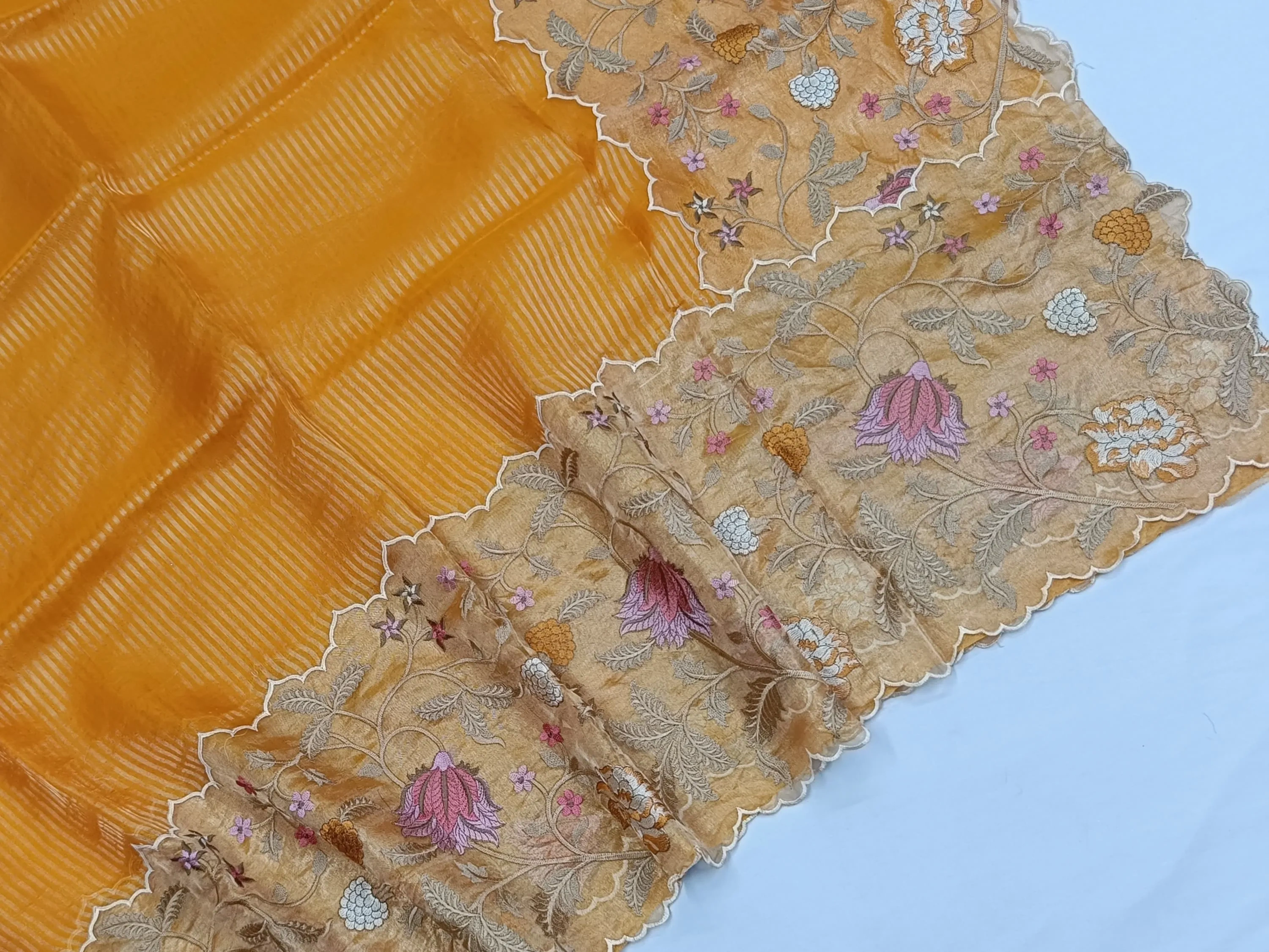 Pure Banarasi Kora tissue saree in golden yellow with intricate gold zari and multicolor floral embroidery on the border