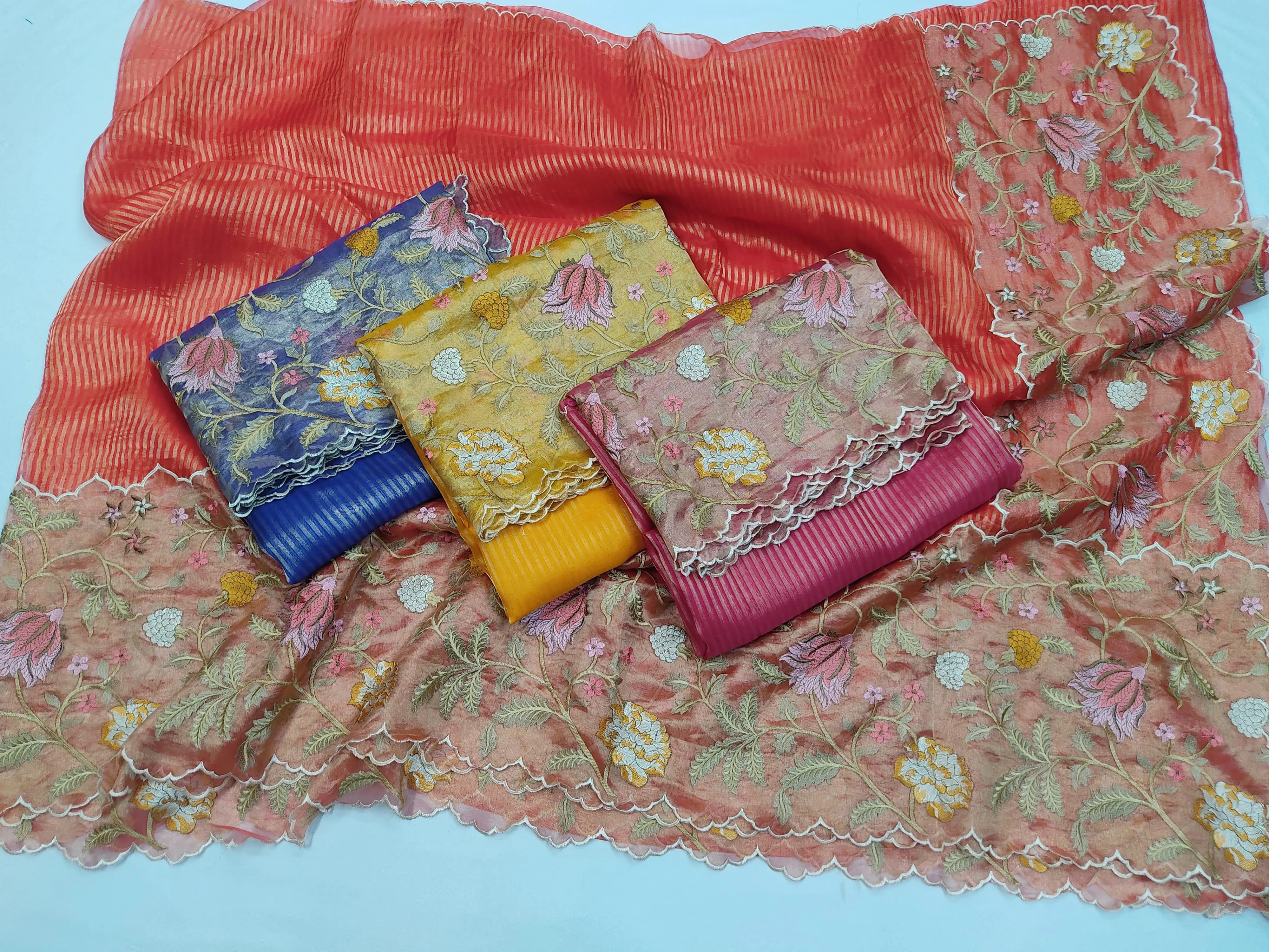 Handwoven pure Banarasi Kora tissue saree in coral with gold and silver zari, floral embroidery, and scalloped border