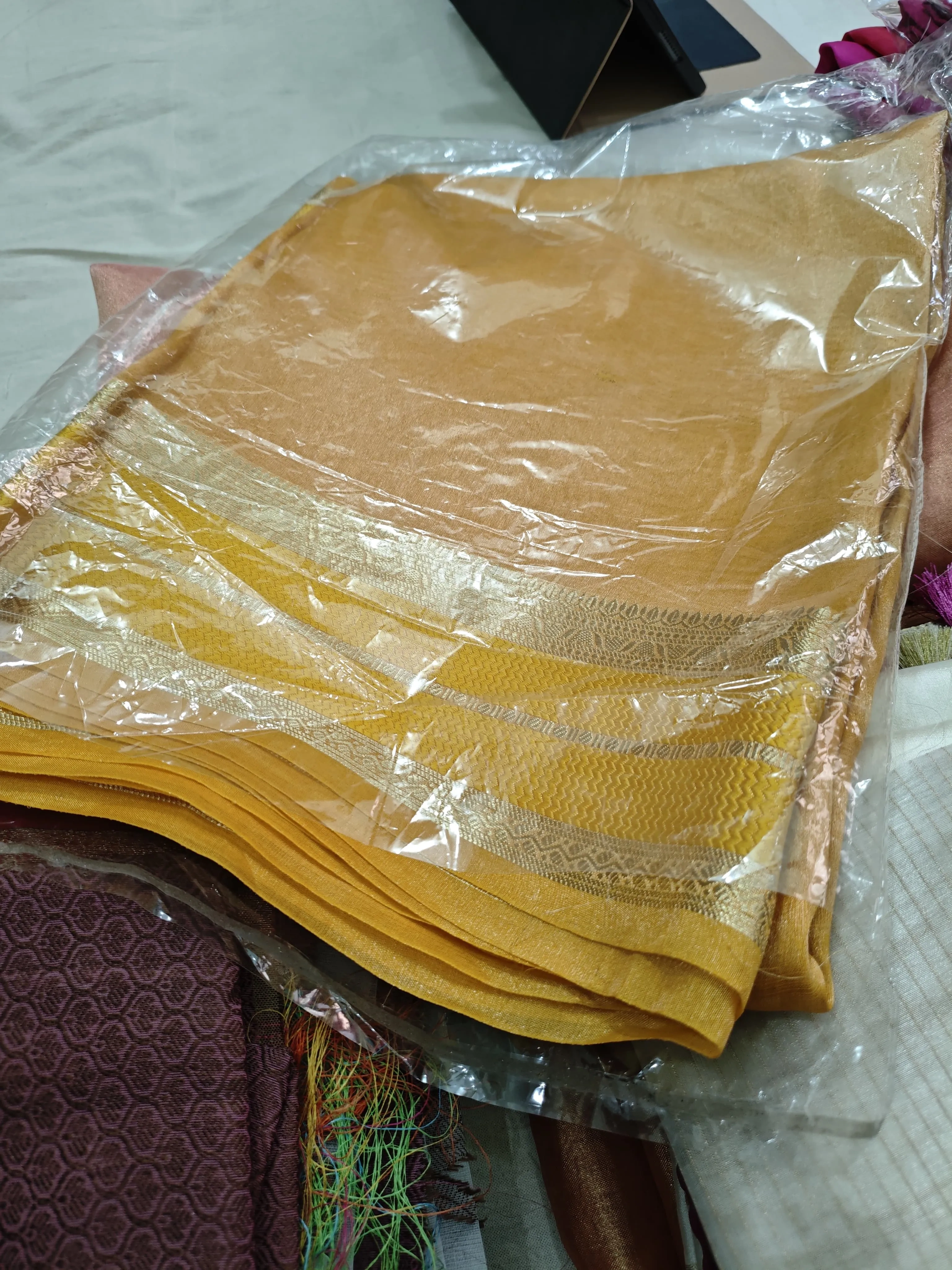 Handwoven pure Banarasi tissue saree in gold with silver zari border, ideal for weddings and festive occasions.