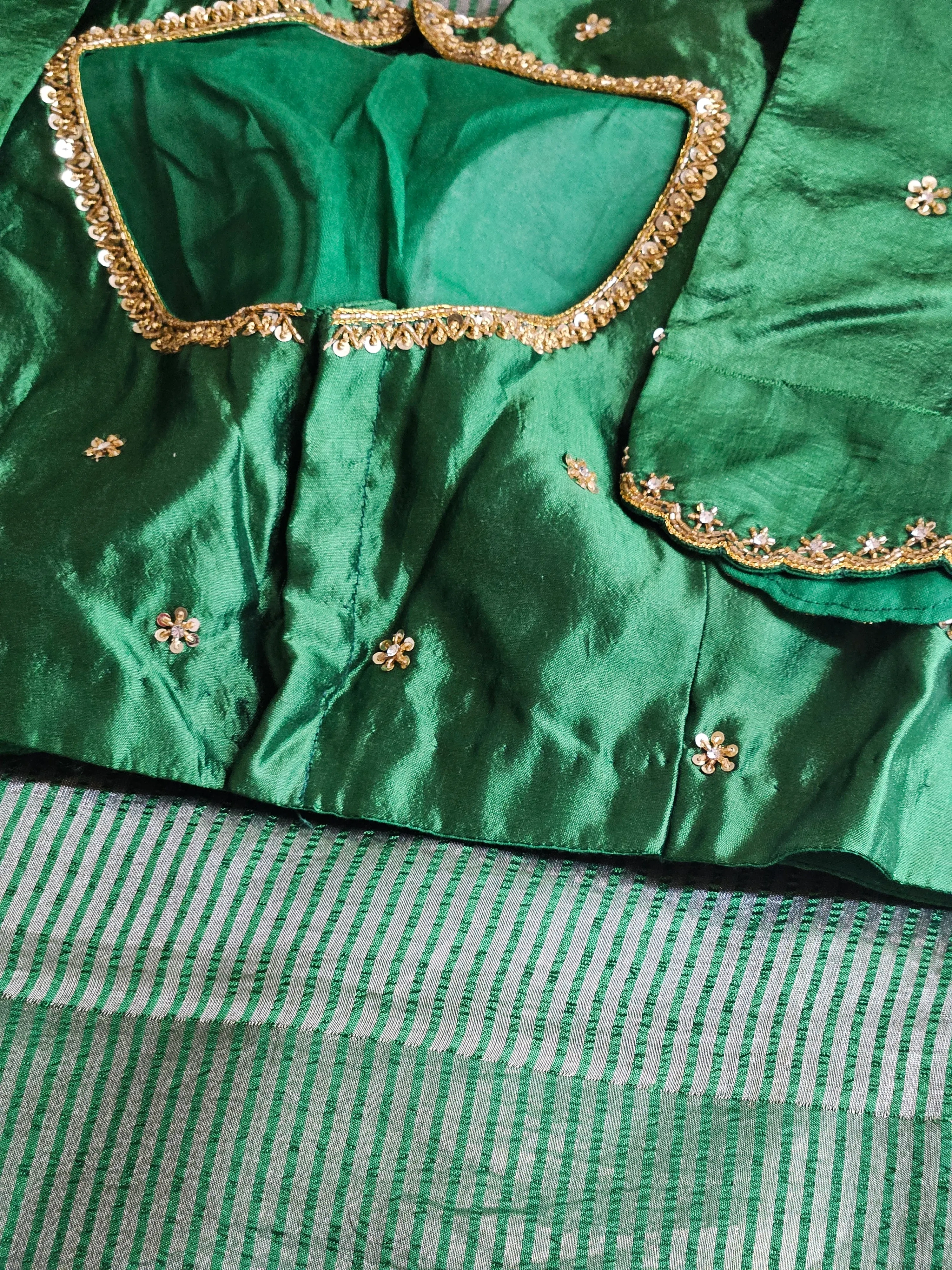 Handwoven Banarasi tissue saree in emerald green with gold-silver zari stripes and paisley motifs, blouse with sequin trim