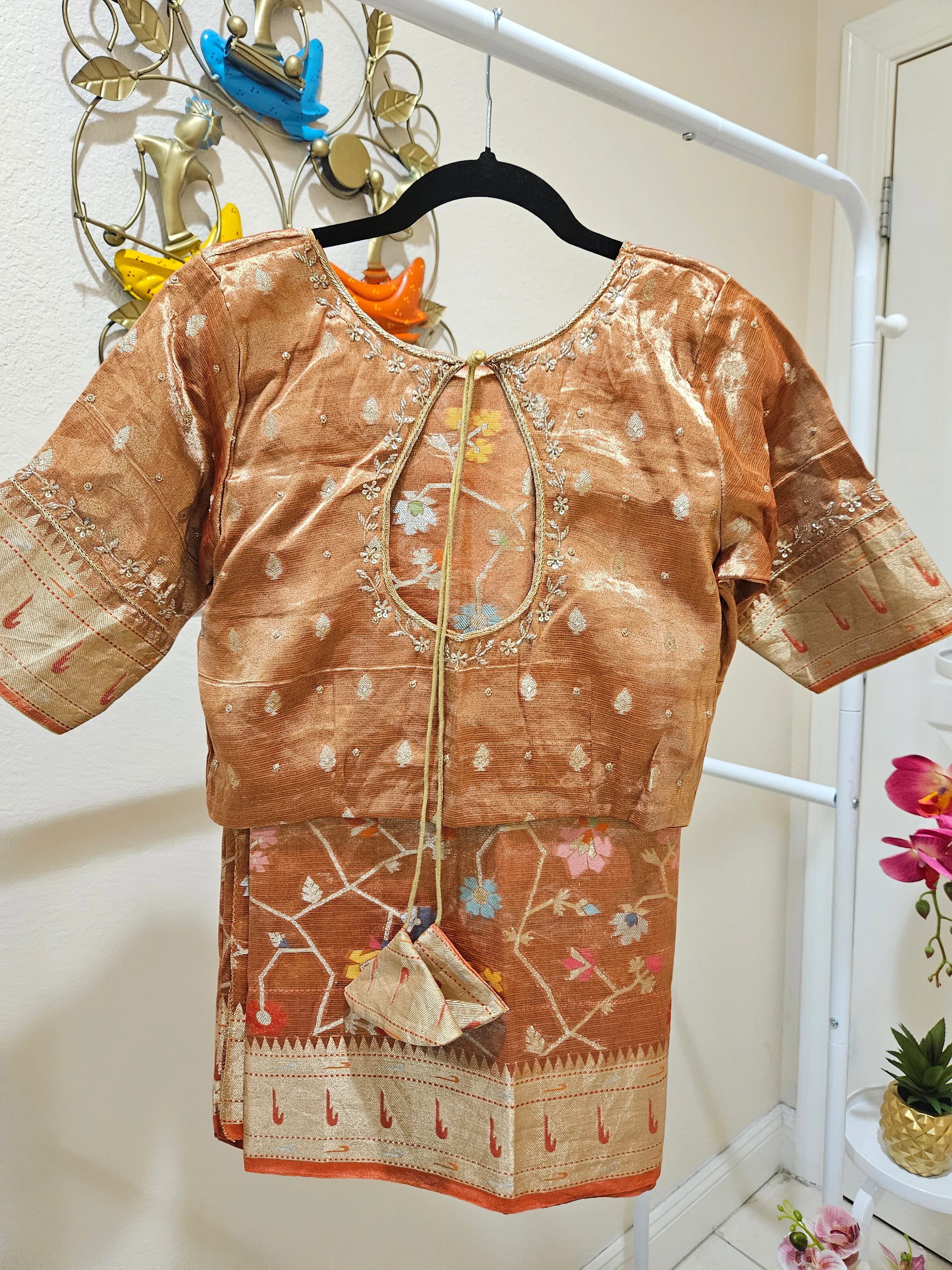 Handwoven pure zari Kota double tissue saree in golden sheen with floral motifs, paired with matching embroidered blouse.