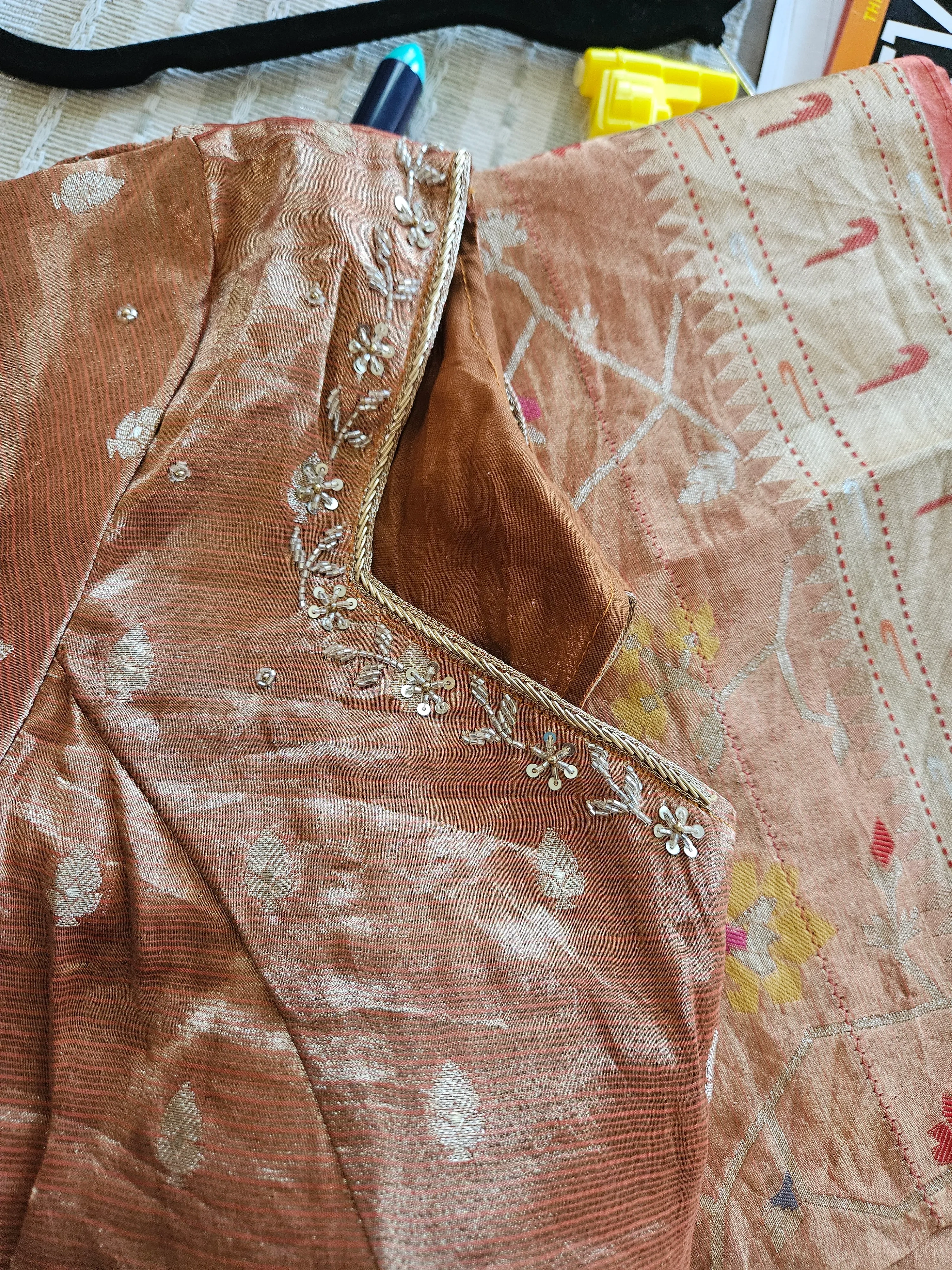 Handwoven pure zari Kota double tissue saree with golden sheen, floral embroidery, and subtle leaf motifs, ideal for weddings.