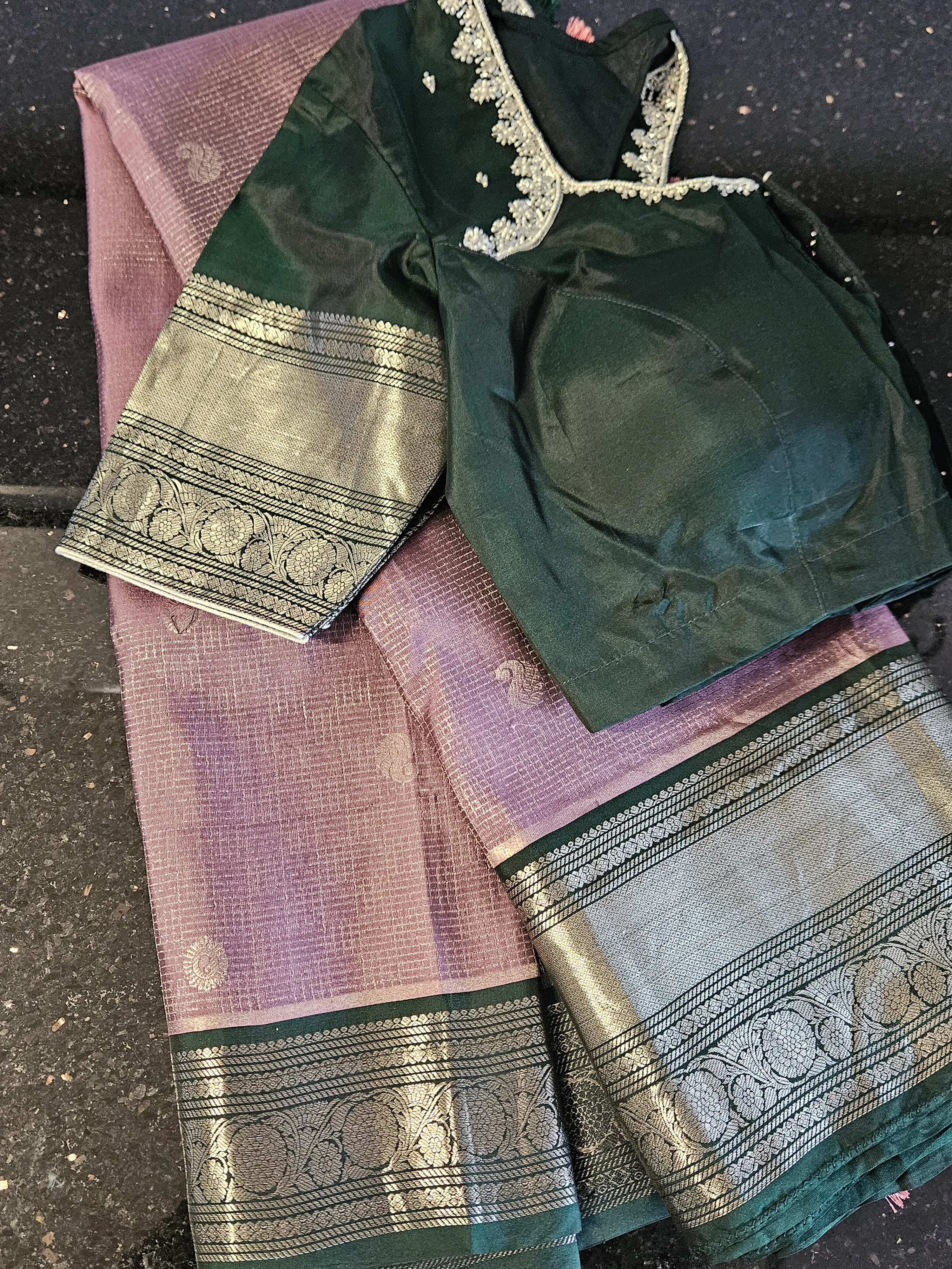 Handcrafted pure Kanchipuram silk wedding saree in mauve with silver zari motifs, paired with a dark green blouse.